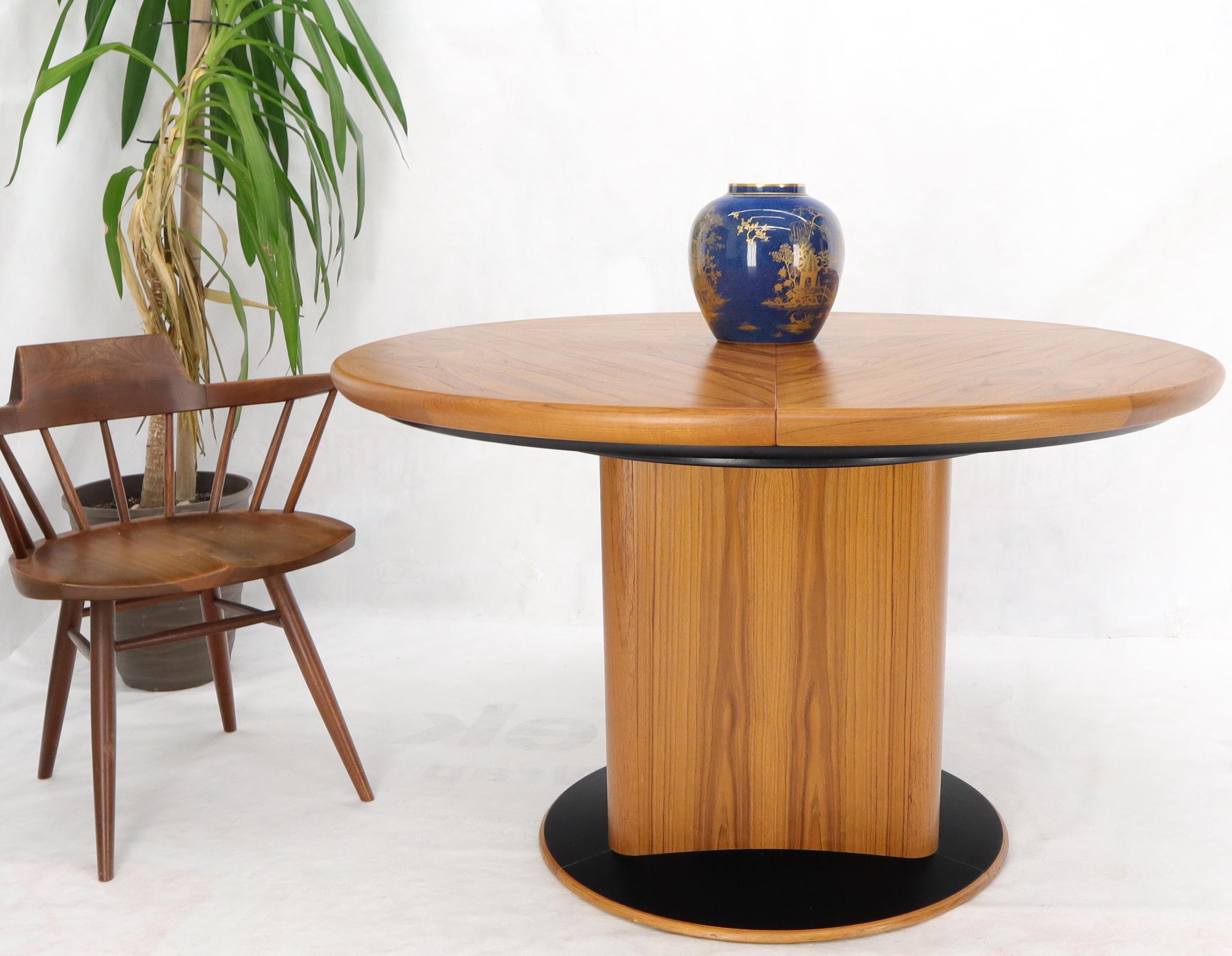 expandable round dining table with self-storing leaves