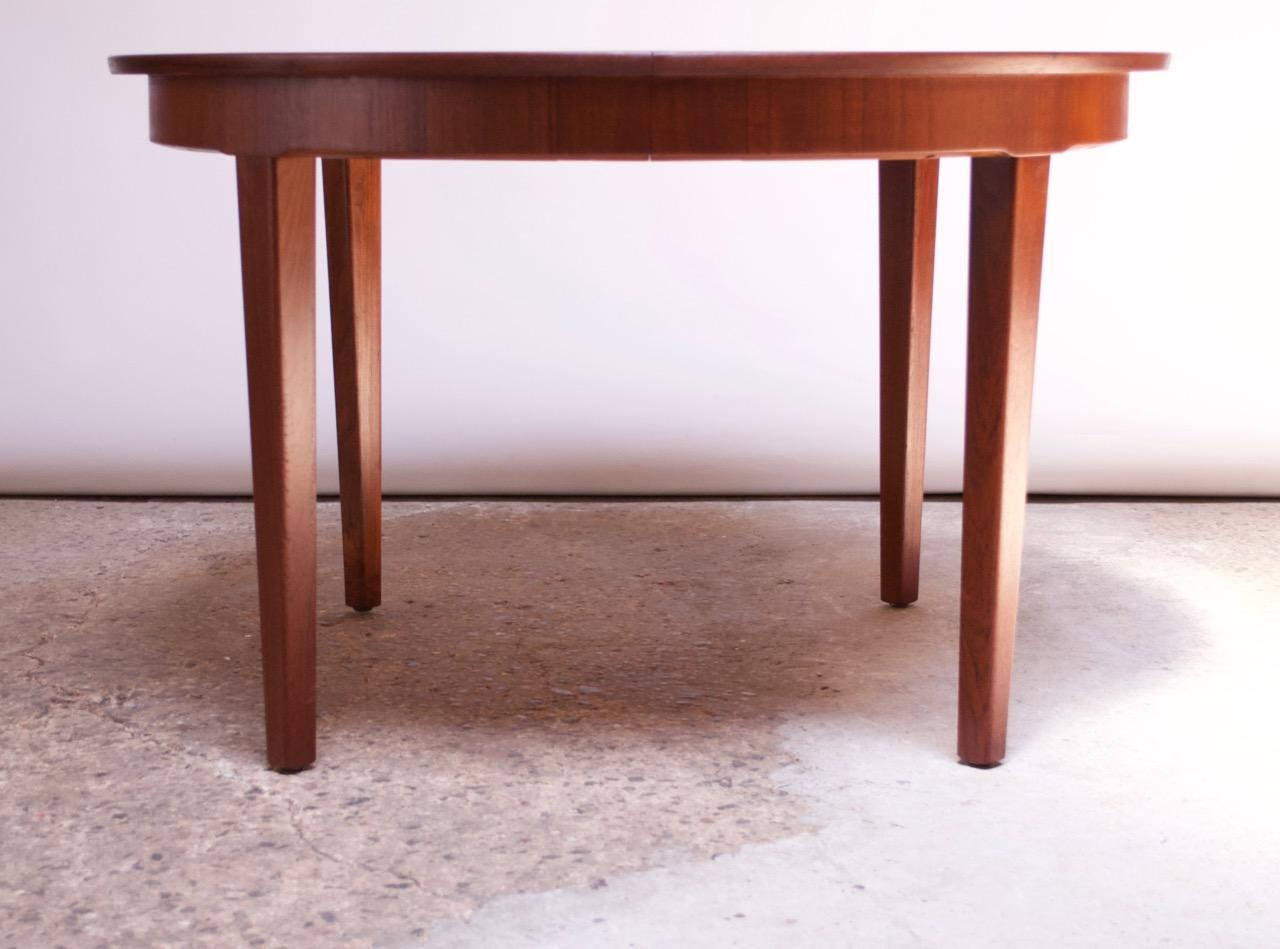 Danish modern dining table manufactured in the 1960s by Skovmand Andersen. Features all three, original leaves, which, when added, extend the circular 47.5
