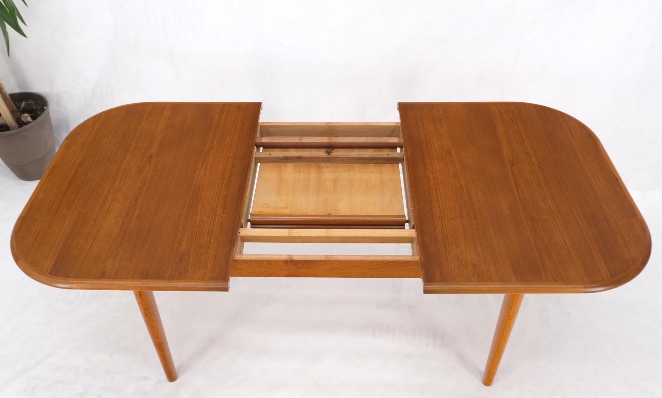 Danish teak rounded corners rectangle dining table one hide away extension board leaf mint.
One table leaf measures 20'' across.