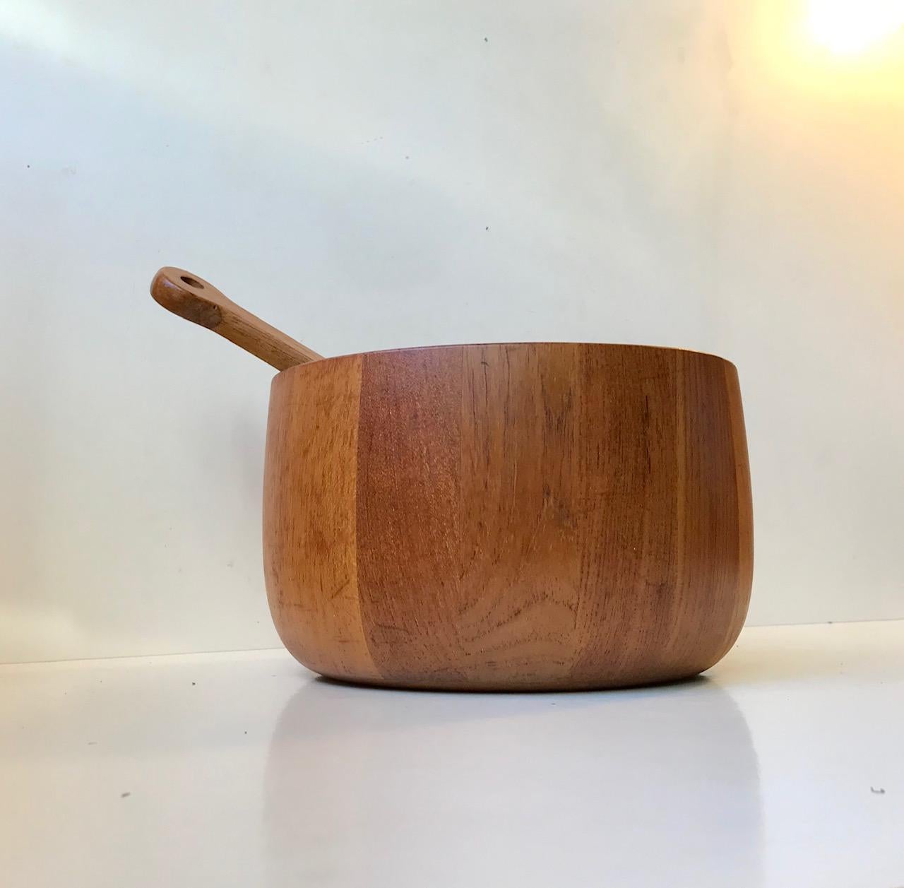 Large hand-turned stacked solid teak bowl by Richard Nissen, Denmark. It was designed and manufactured in the early 1960s. Nissen collaborated with Illums Bolighus in Copenhagen during this period. The bowl comes with a salad serving set also from