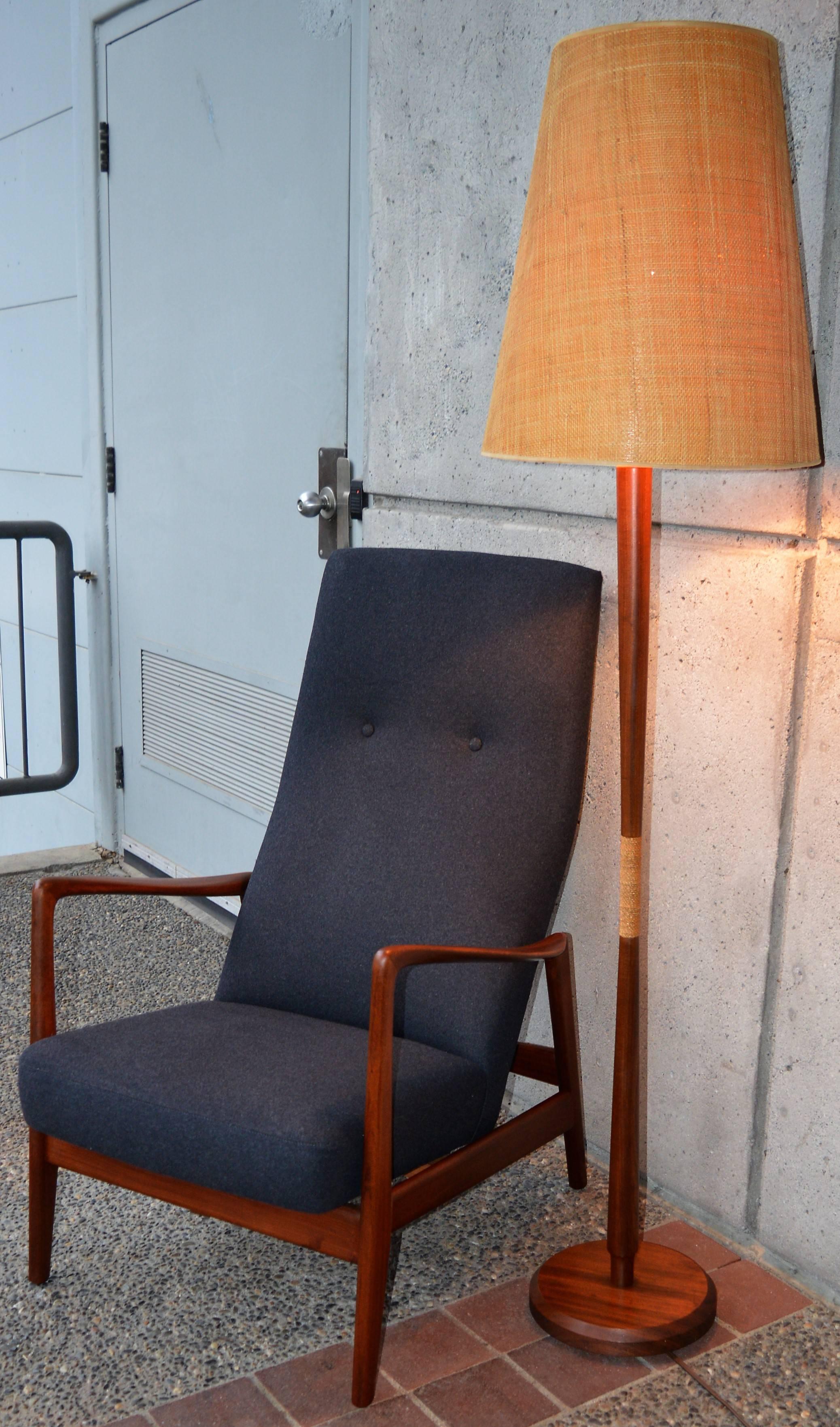 This gorgeous and unique Danish modern teak floor lamp has lovely sculptural detailing throughout, a rich dark patina, a jute wrapped centre and the original grass cloth conical shade is stunning. In fabulous condition, with a few minor tiny pin