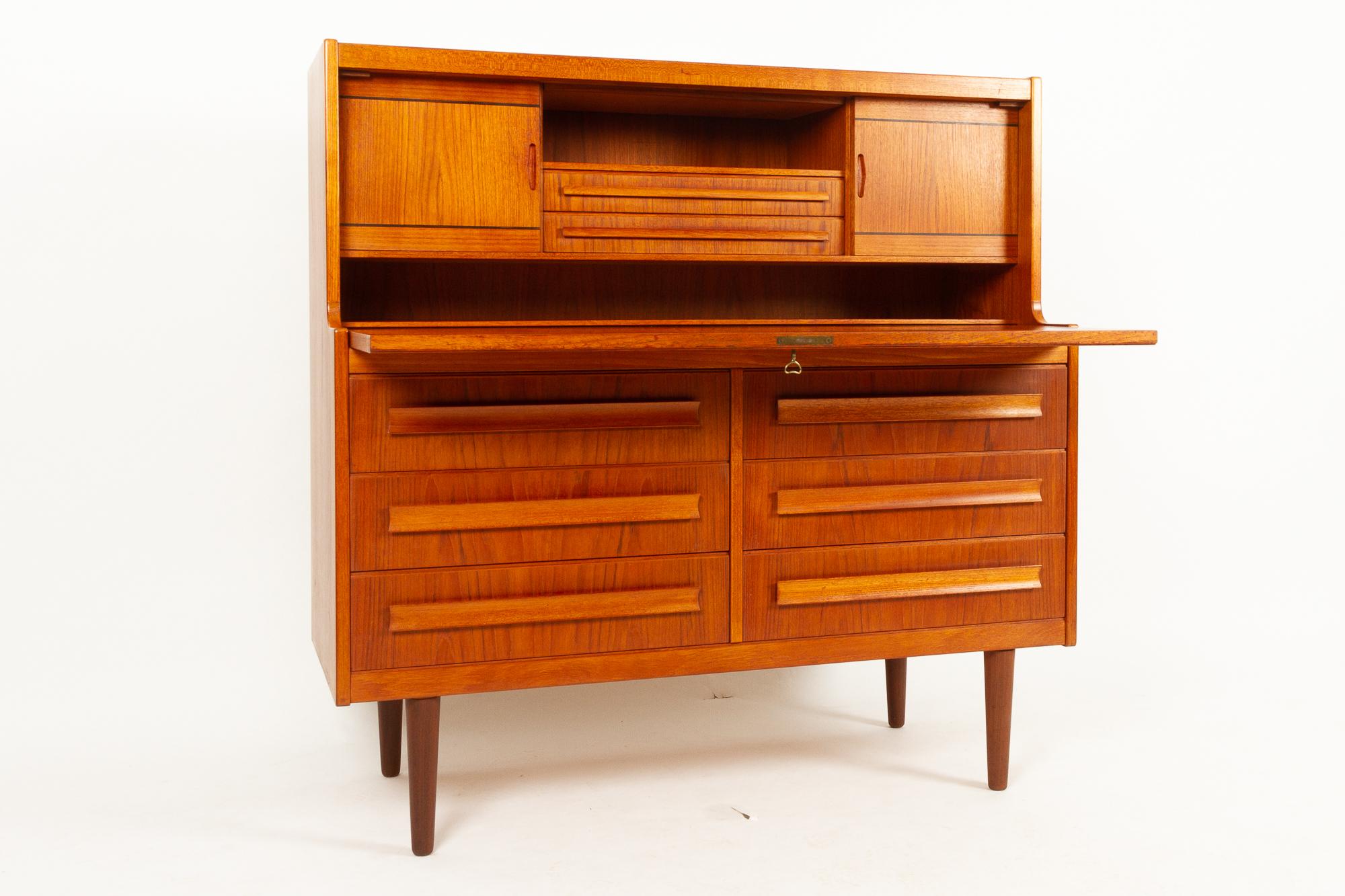 Danish teak secretaire with hidden compartment by Sigfred Omann for Ølholm Møbelfabrik 1960s.
Very stylish Mid-Century Modern teak secretary with drawers, cabinets and flip down tabletop. 
Rarely seen model, very fine craftsmanship and high