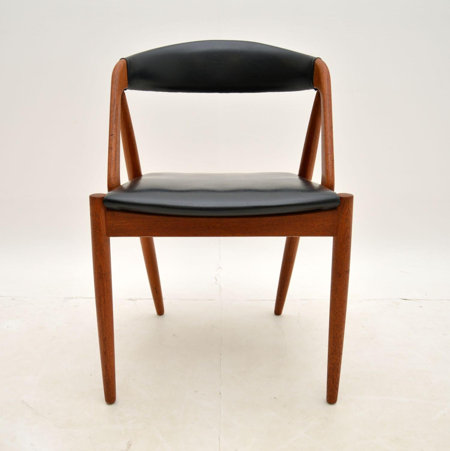 A wonderful and iconic Danish chair in solid teak. This model 31 chair was designed by Kai Kristiansen and it dates from the 1960’s.

It is of superb quality and has a stunning design. The solid teak frame is upholstered in black vinyl, it has a