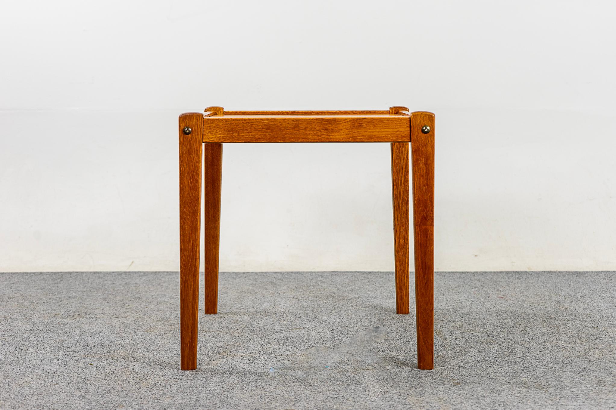 Teak Danish side table by Spottrup, circa 1960's. Solid wood construction on the base and handsome book-matched veneer on the flat surfaces. Compact, highly functional table pairs perfectly with lounge chairs.

Please inquire for international