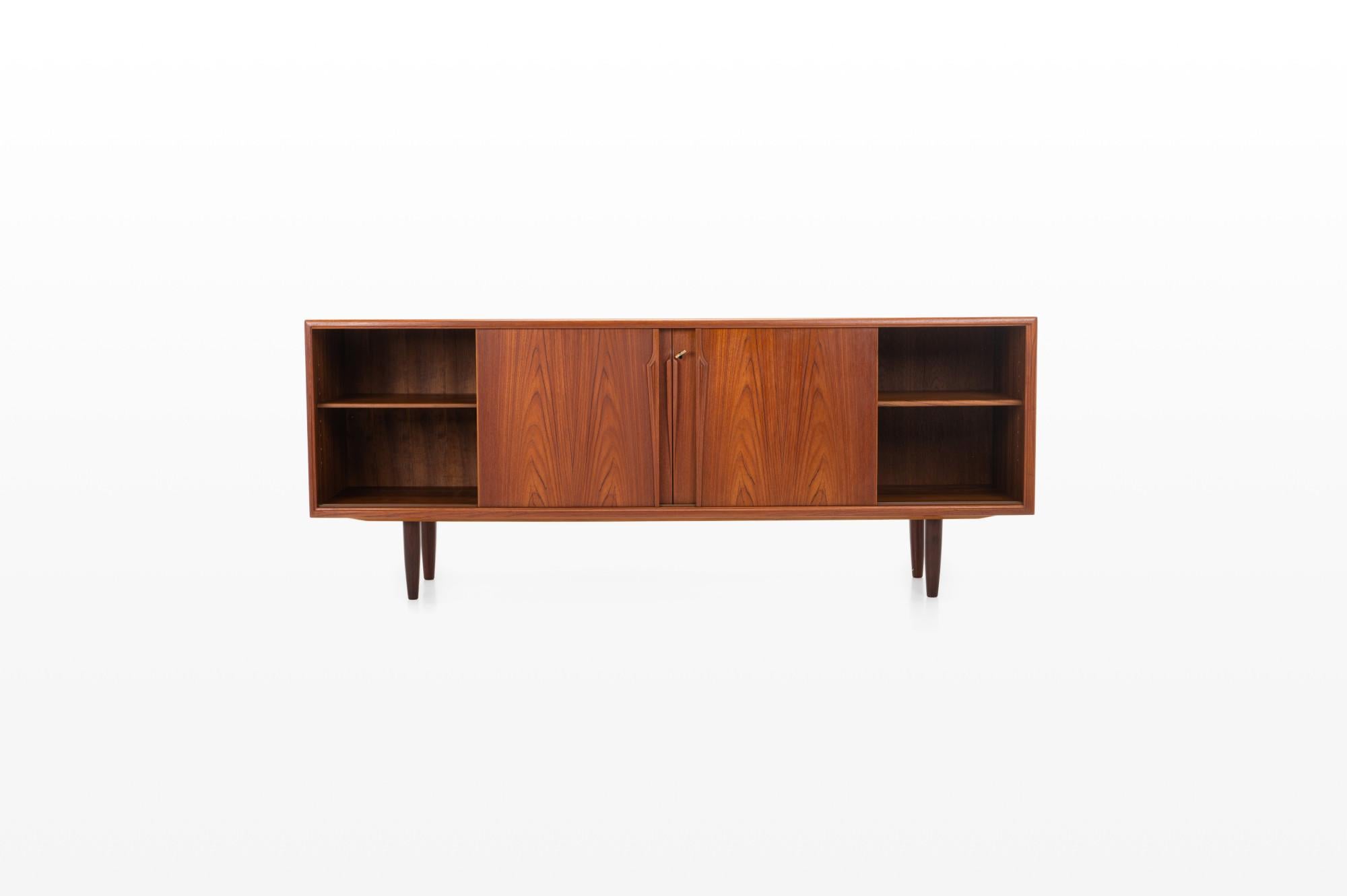 Vintage sideboard by Axel Christensen for ACO Møbler, Denmark 1960s. Beautifully designed sideboard in teak with elegant handles, four sliding doors, three inner drawers and plenty of storage space with adjustable shelves. There is also a lock on