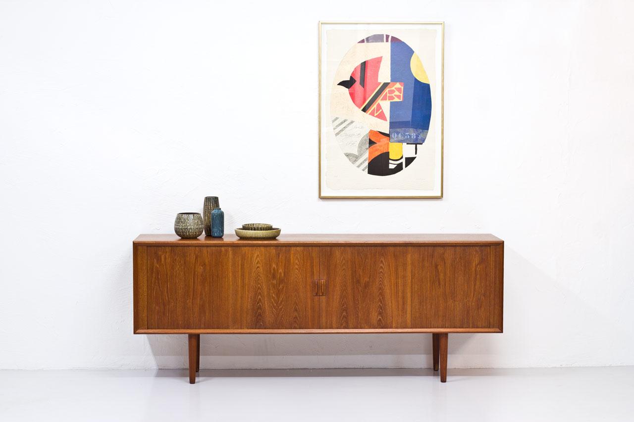 Sideboard designed by Svend Aage Larsen. 
Manufactured in Denmark by Faarup Mobelfabrik during the 1960s.
Made from teak with tambour doors. Inside with drawers and shelves.