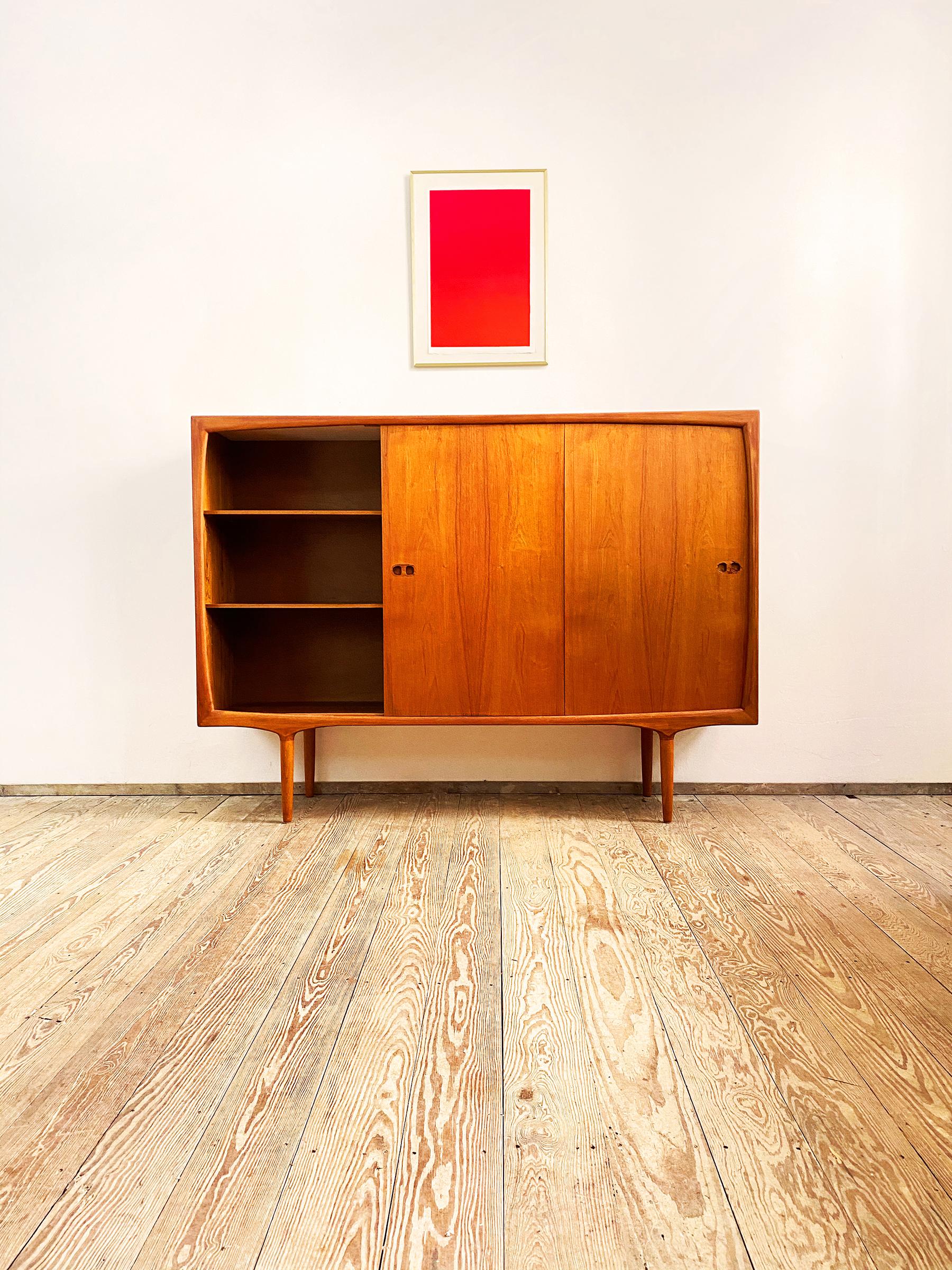 This Scandinavian Mid-Century Modern teak credenza was designed in the 1950s by Harry Østergaard for Randers Møbelfabrik in Denmark.

It shows exquisite Danish craftsmanship and offers plenty of storage space on four tapered legs and lots of