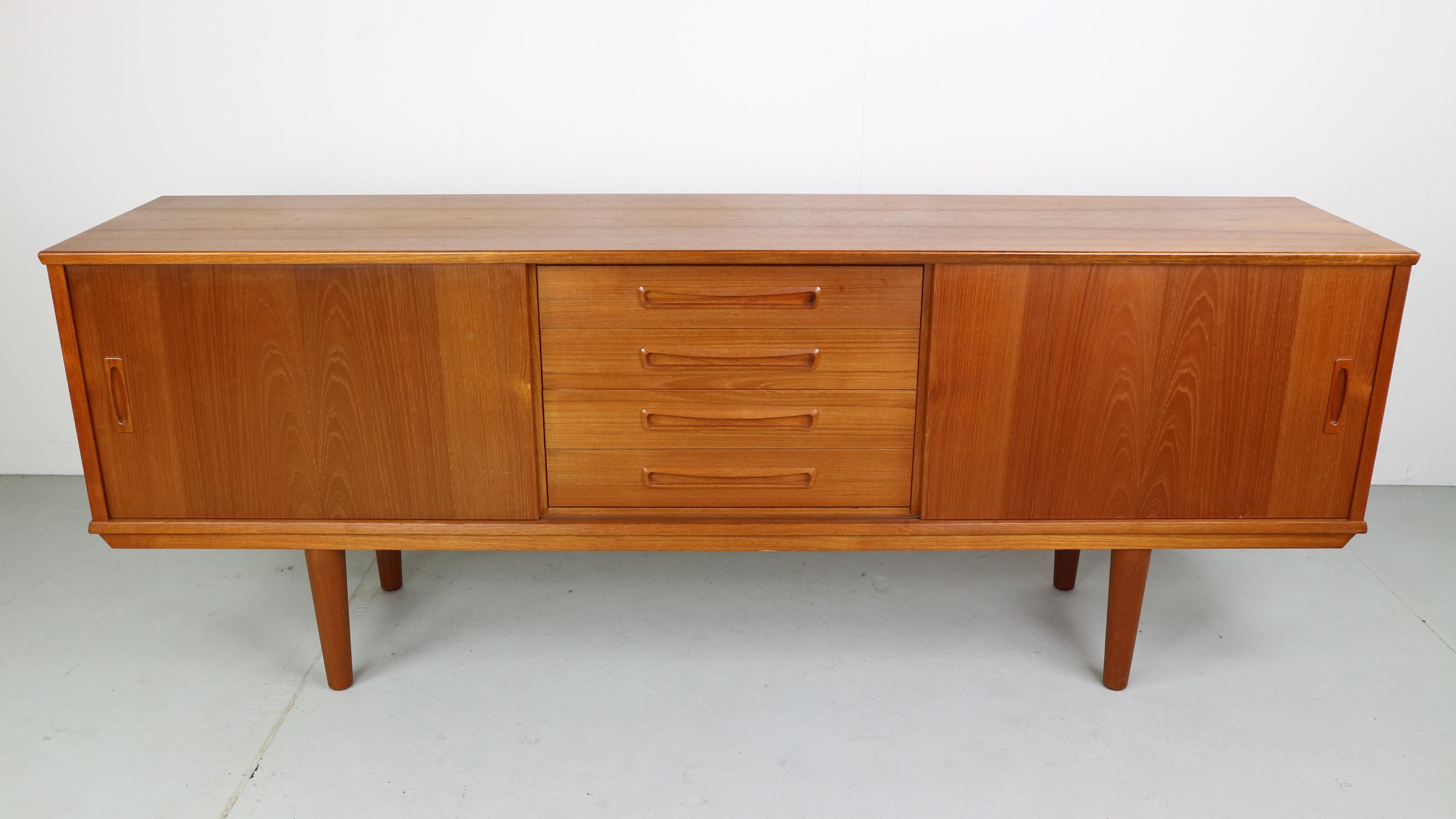 Teaks wood sideboard with 3 drawers and sliding doors, made in Denmark 1960s.
Stamped by the maker.