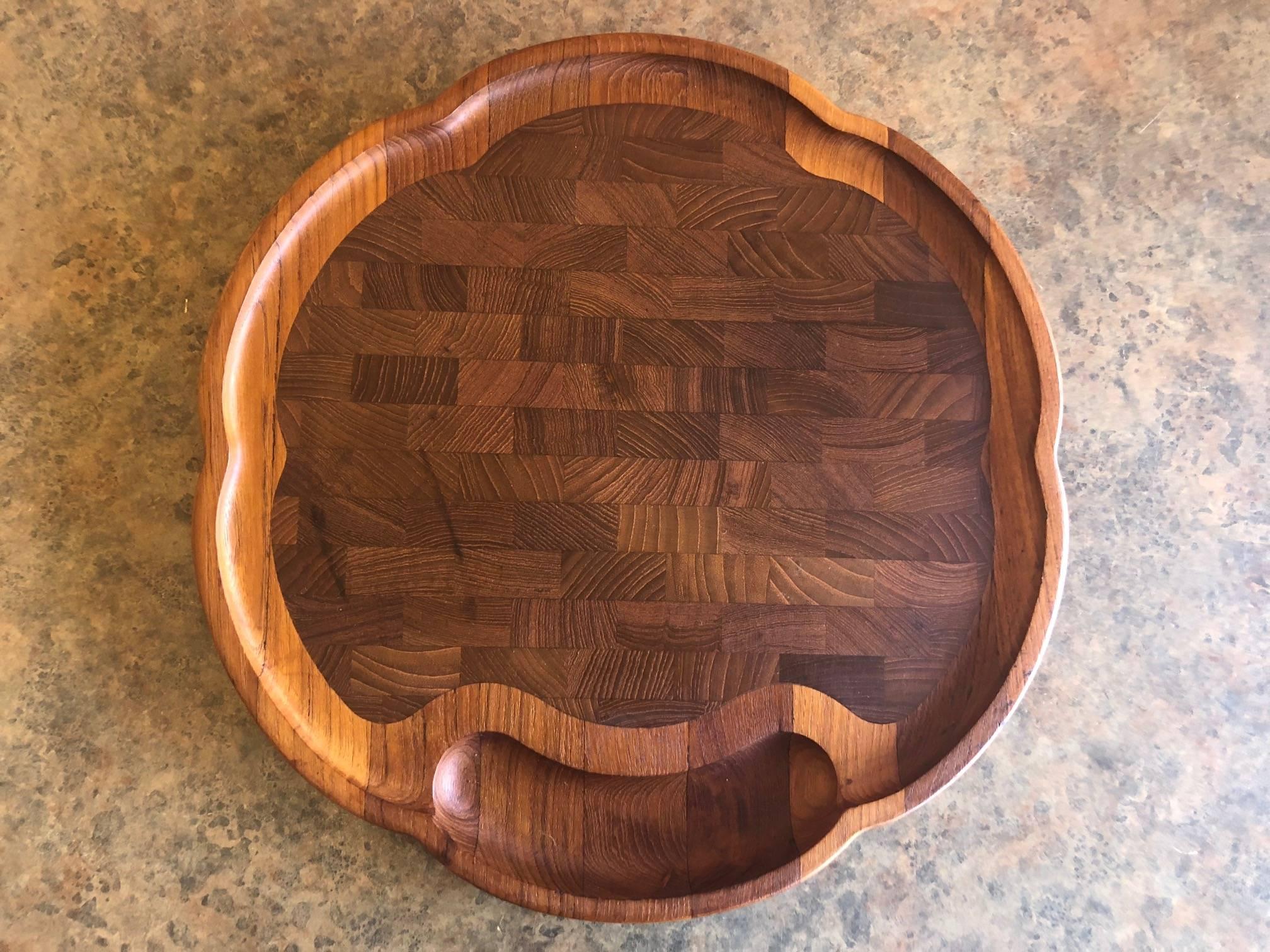 Rare, scalloped edge, Danish teak sloped cutting board by Richard Nissen, circa 1960s. The piece has a butcher block design and is 15.75