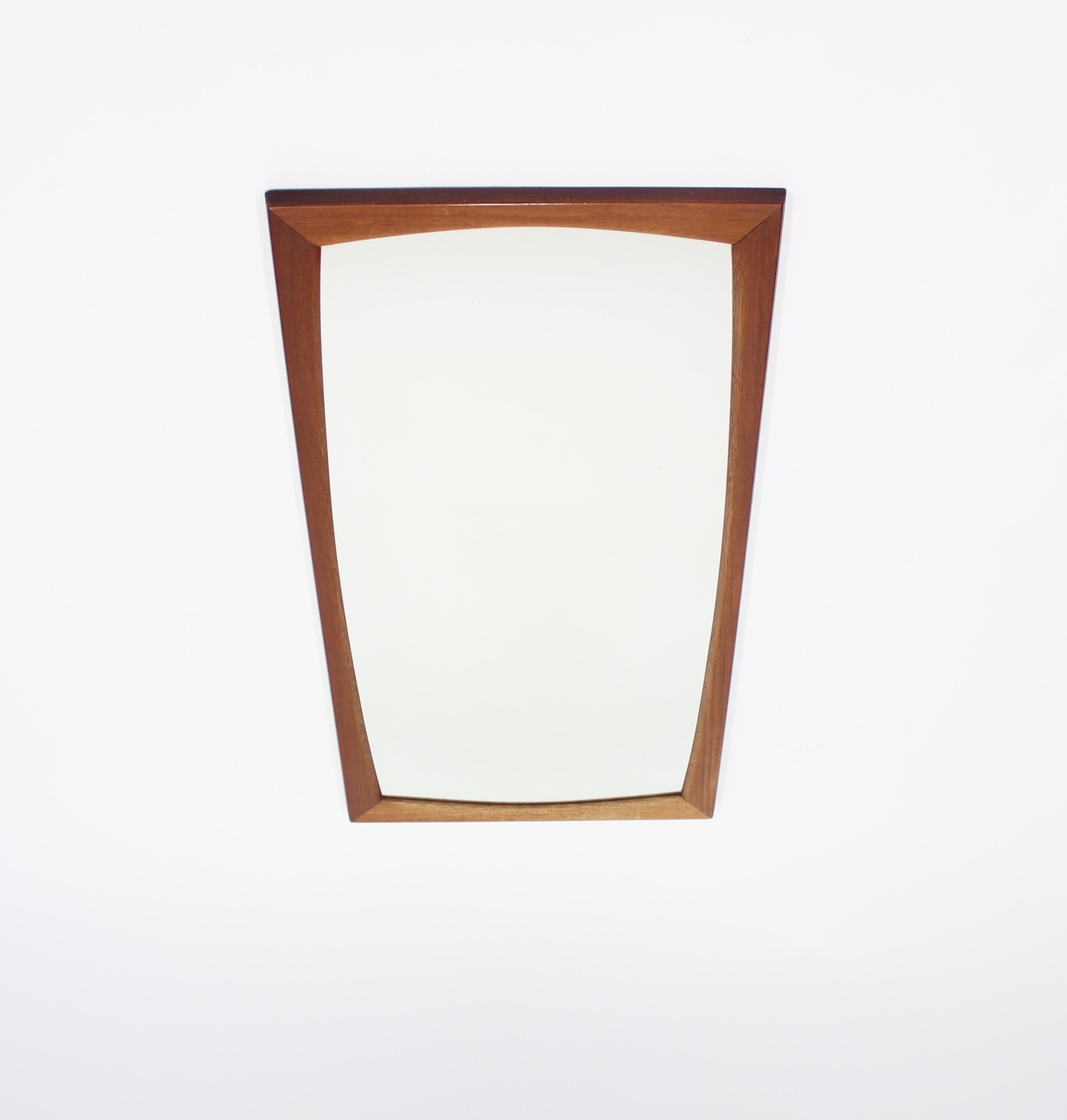 Kai Kristiansen designed mirror for renowned Danish manufacture Axel Kjersgaard. The mirror is made from solid teak with its original glass. Marked with the Danish Furniture makers control mark and by maker as well. Very good condition.
