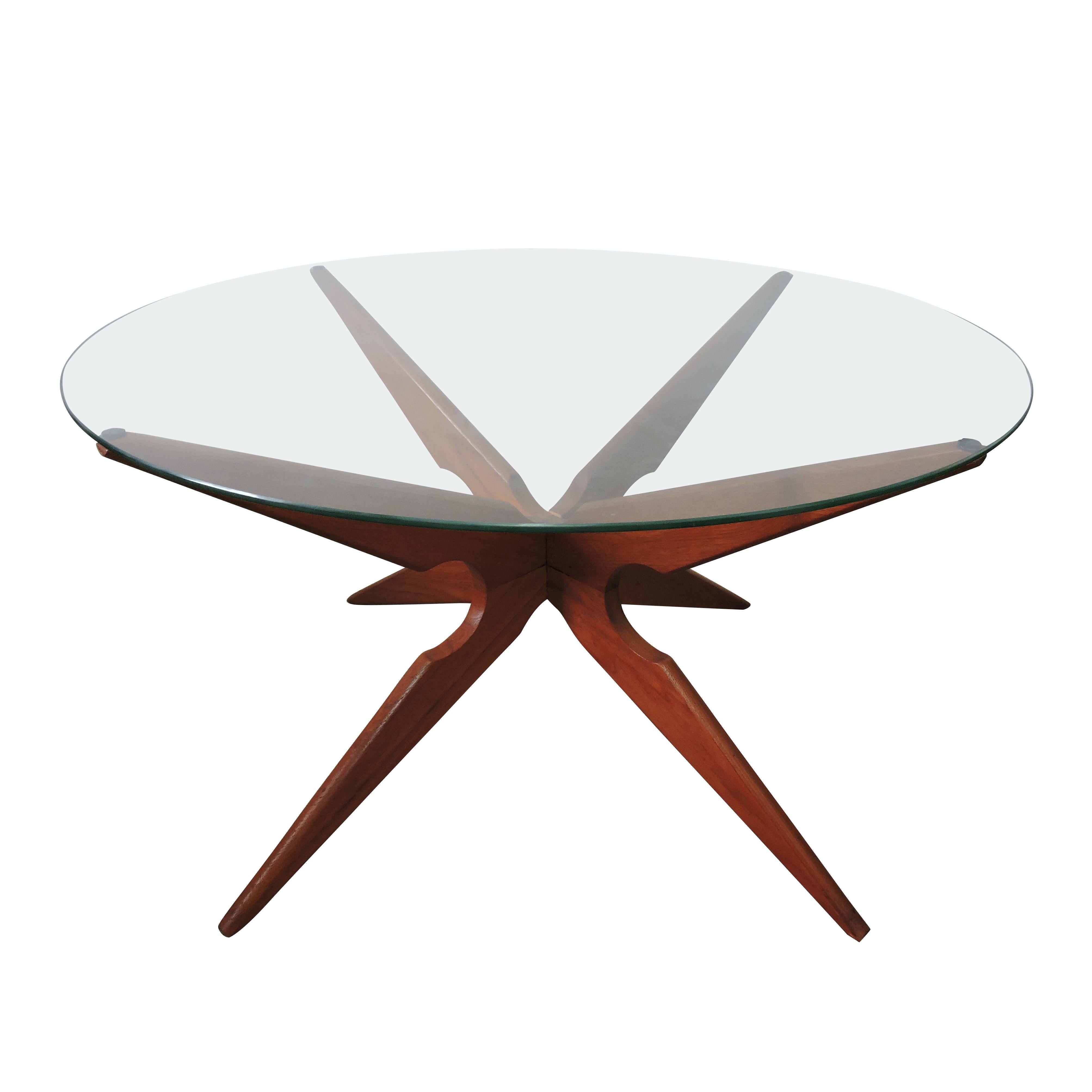 Sika Mobler glass 'Spider' coffee table.
Featuring a two part base that slots together to form the star, and a round glass table top. The glass has light scratches as expected with the age of the piece.