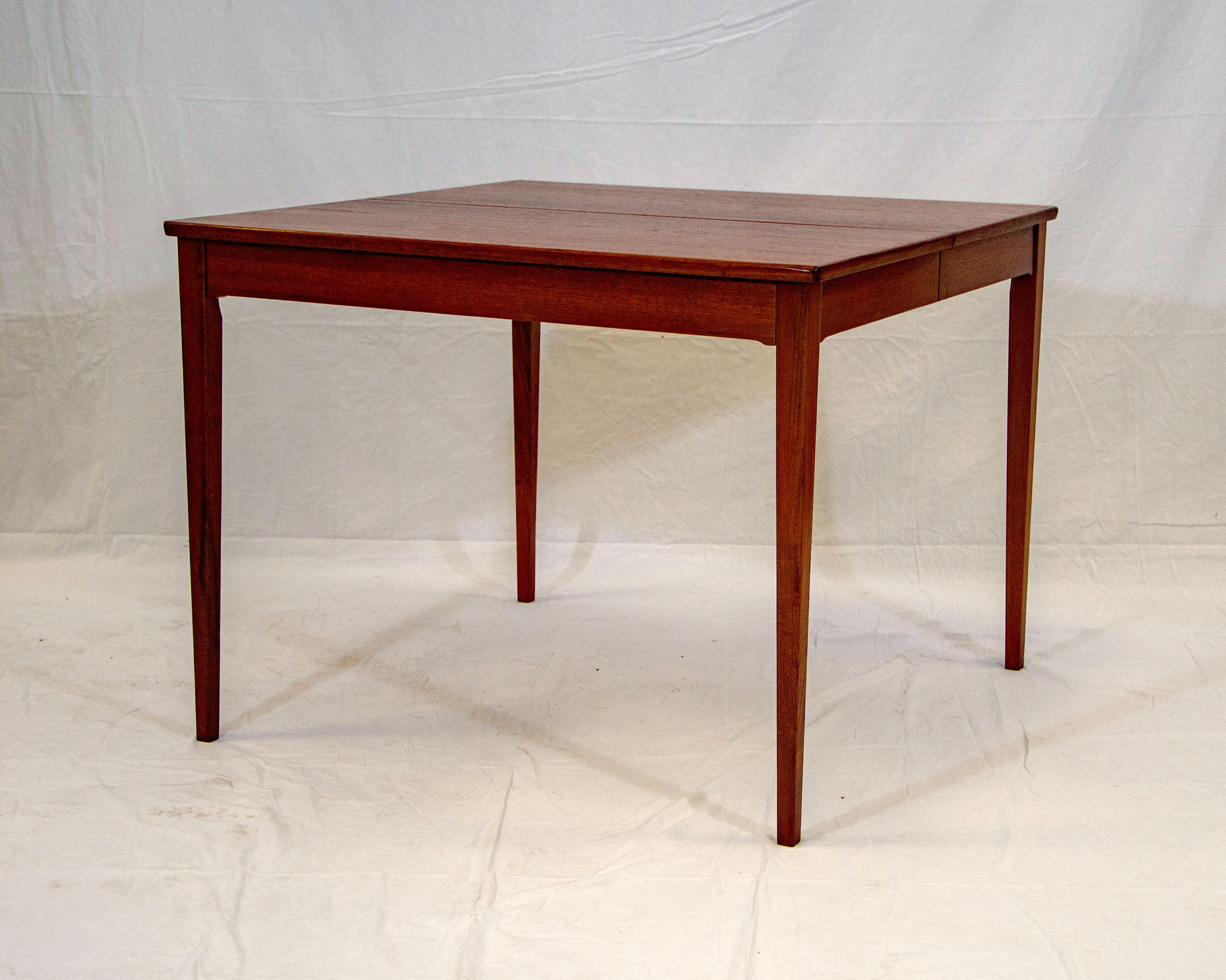 Smaller size square Danish teak dining table designed by Svend Langkilde and manufactured by Langkilde Møbler with two 19