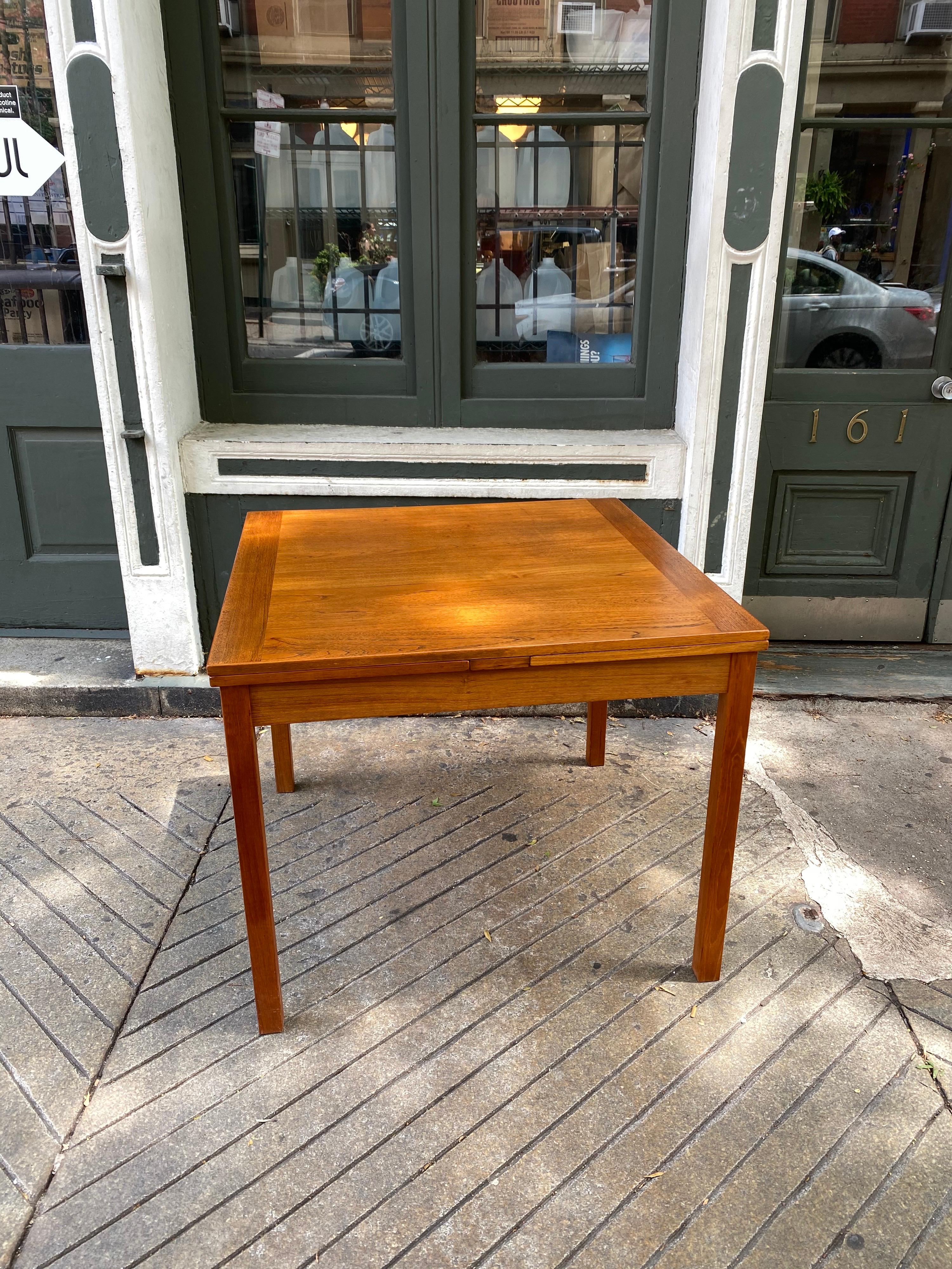 Danish teak square table with pull-out leaves. Usually found in a rectangular form, square models are harder to find! Original finish, shows a couple scratches to leaves as seen in photos. Overall very nice original condition! Perfect for dining or