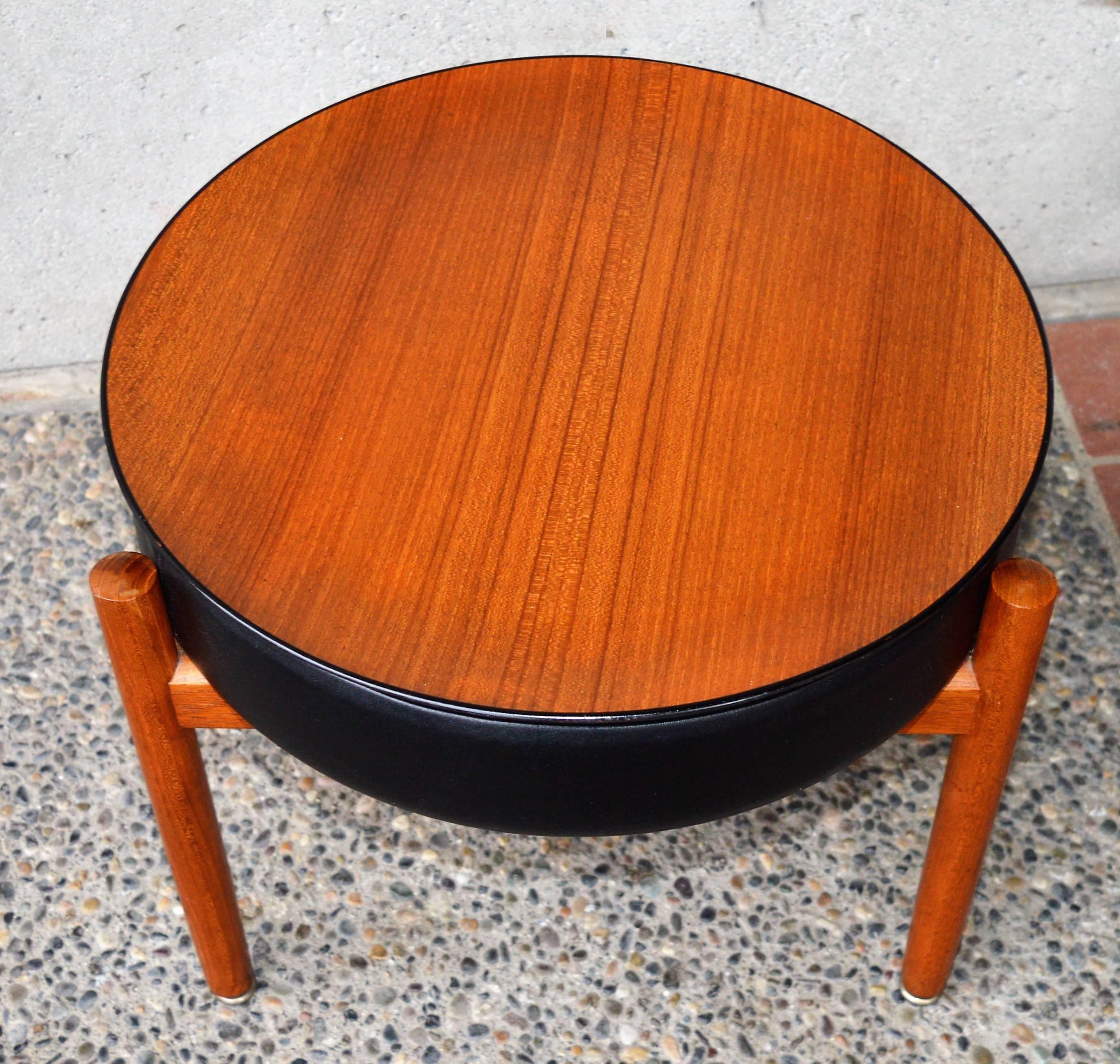 This lovely and practical Danish modern teak stool or ottoman was designed by Hugo Frandsen for Spottrup in the 1960s. We've added the perfect bent ply teak round tray to serve as a tabletop to make it even more practical! The three legged solid