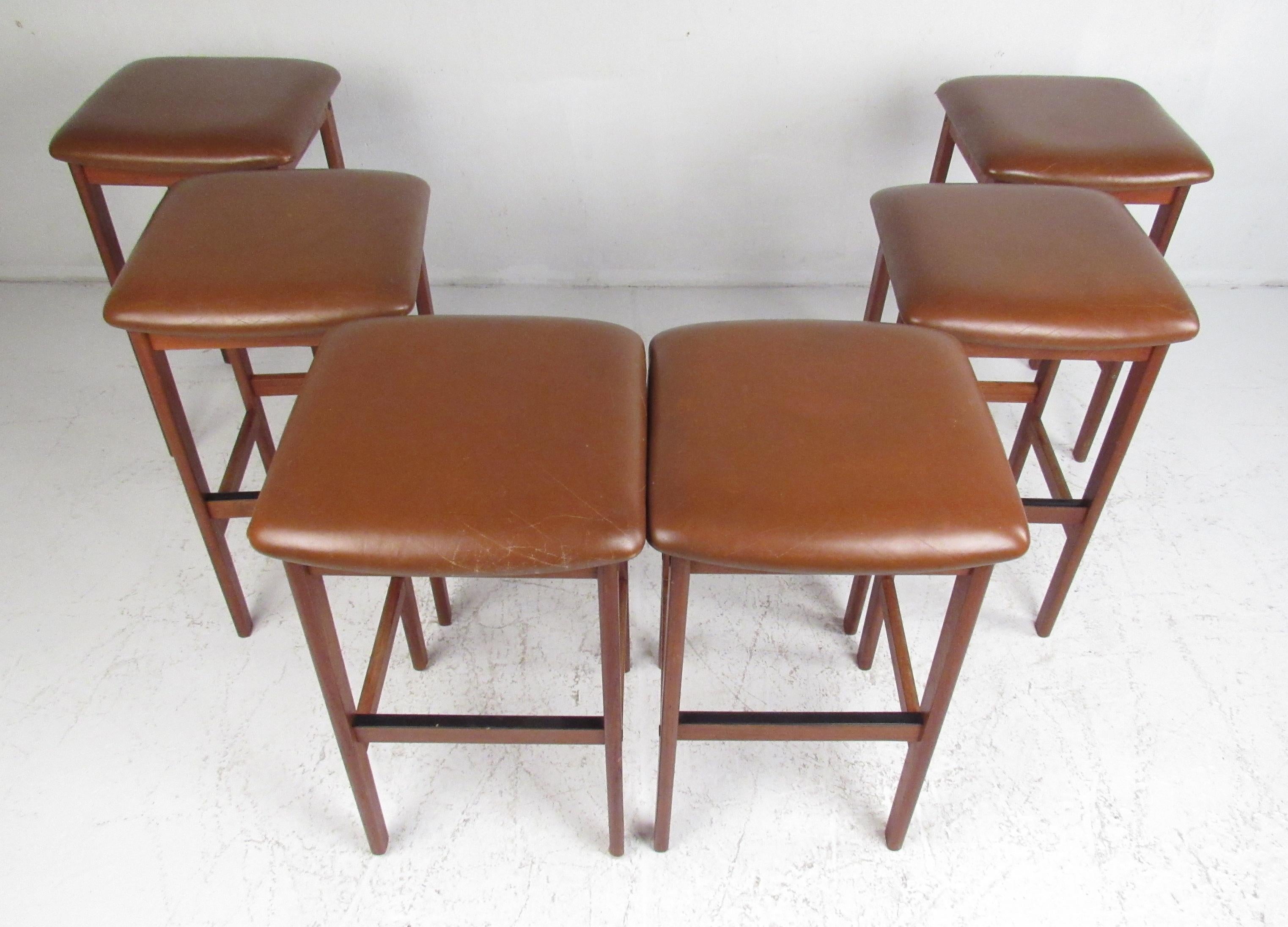 Set of six Scandinavian Modern teak frame and leather seat stools by Korup Stolefabrik. 
The price noted is per stool.
Please confirm item location (NY or NJ) with dealer.