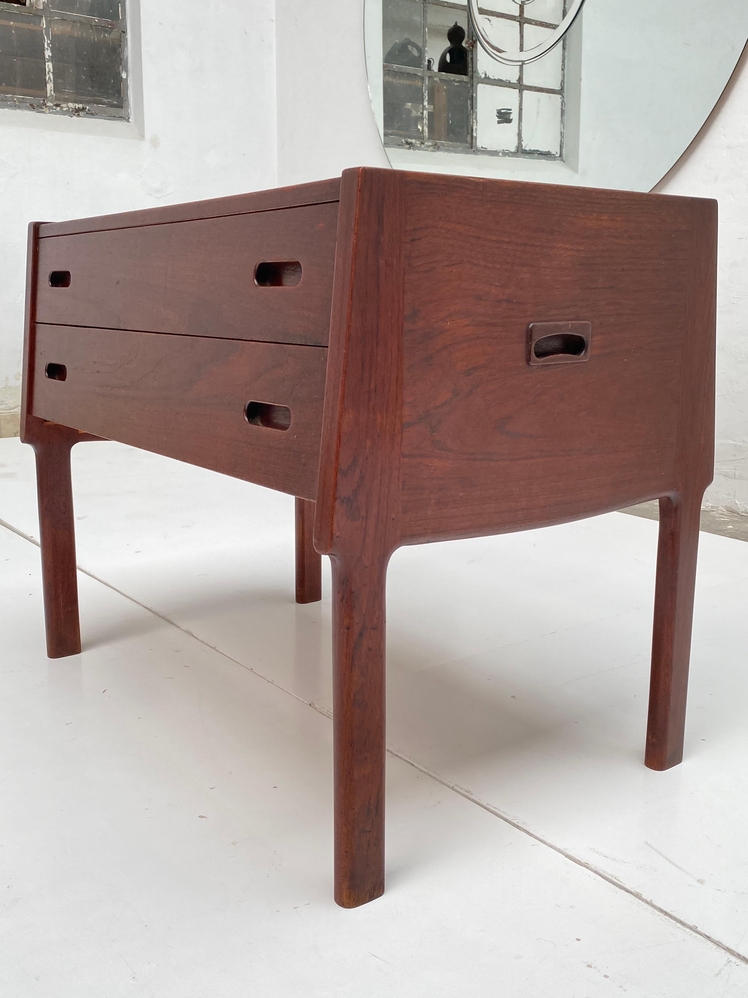 Very beautifully executed Teak compact cupboard from Denmark

The cupboard has 2 functional spacious drawers with double handles
The top drawer has a sewing material layout and can be easily pulled out to be stored on top of the cabinet for a goof