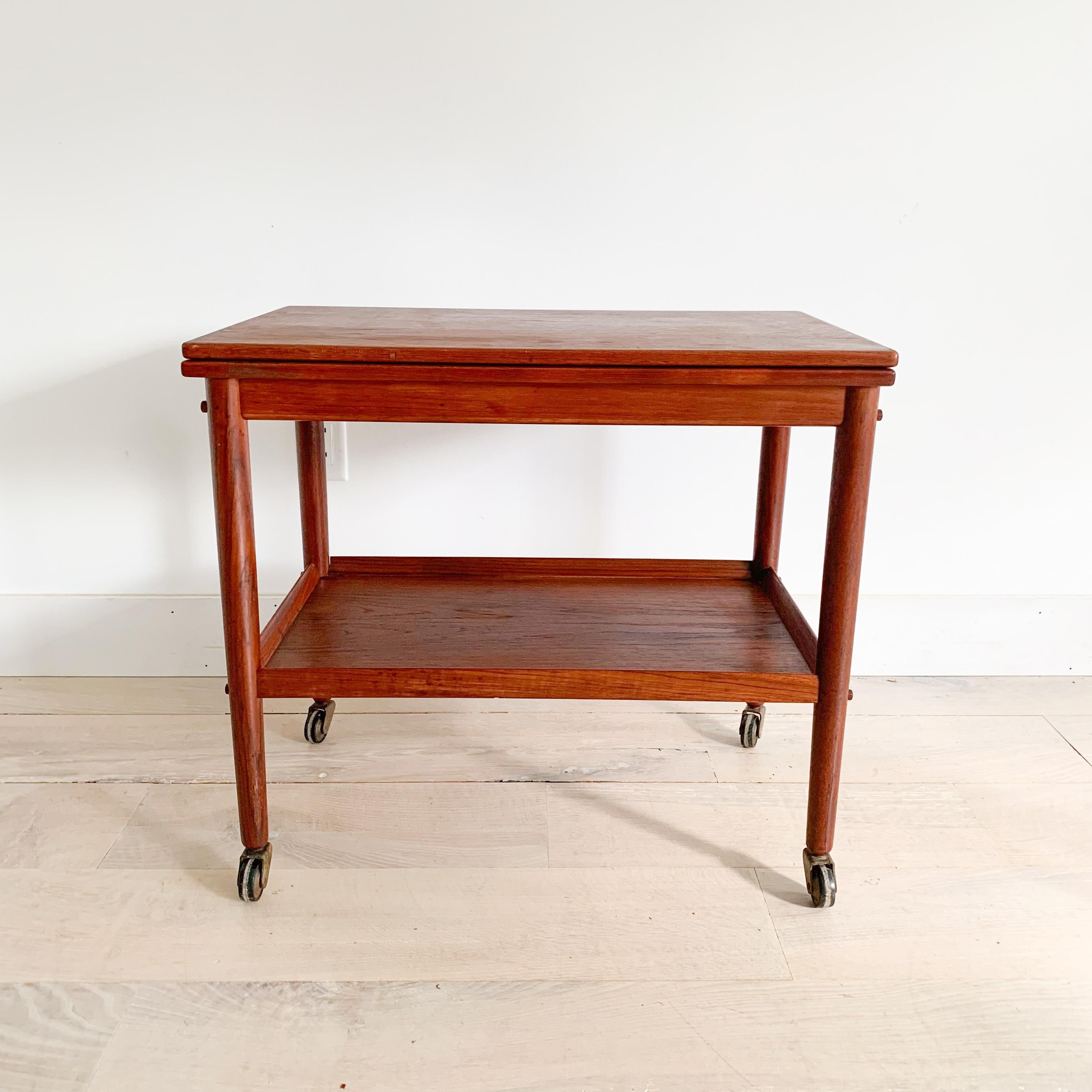 Hard to find mid century modern danish teak bar cart by Grete Jalk for PJ with swivel expandable top! Some light scuffing/scratching from age appropriate wear.

27.25