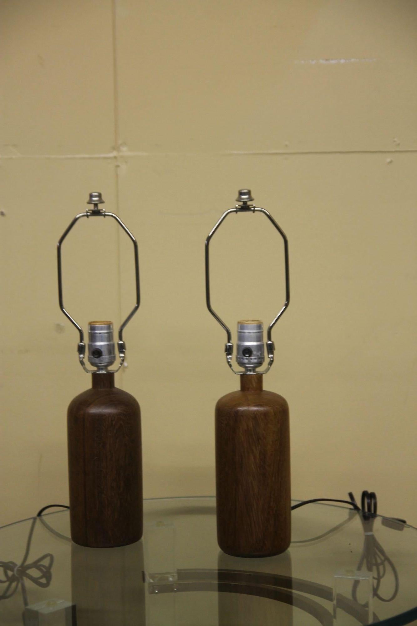 Nice pair of smaller scale Danish teak table lamps. Lamps are in great vintage condition.