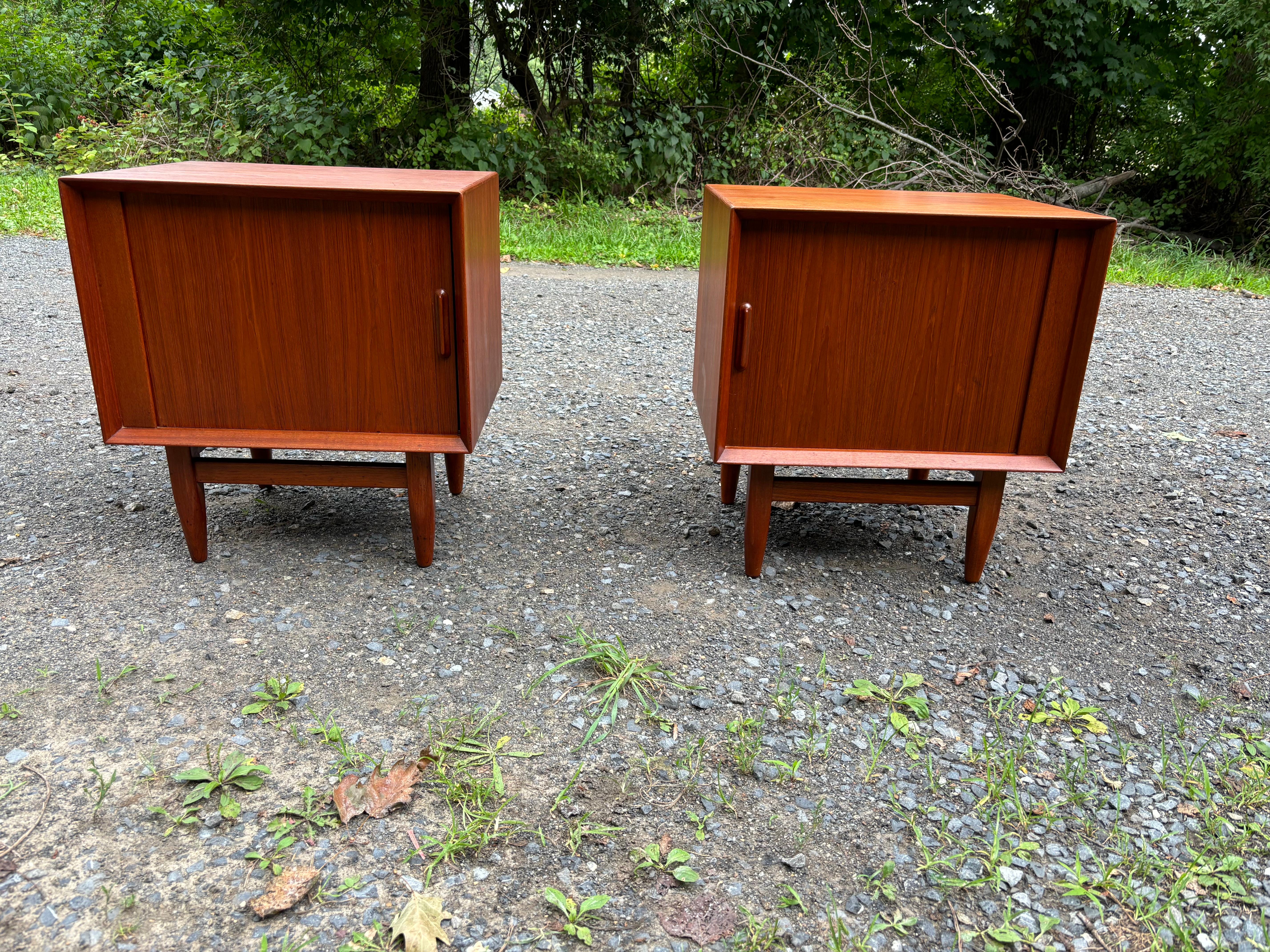 Pair of Falster made in Denmark Teak Tambour Door Nightstands.  Original Condition still presents very well!  Stains to one bottom interior and only one upper drawer between the two.  Tambour Door is a nice unusual feature!  Nice Scale and Size!