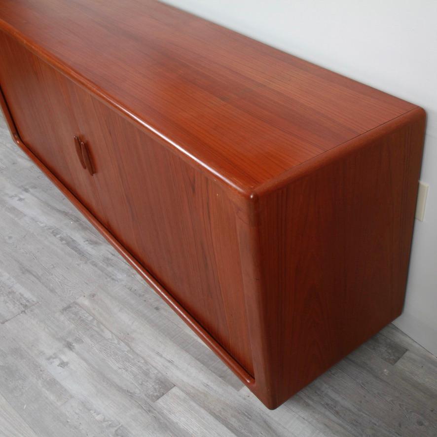 While the tambour door has been around for centuries, the Danish modern pieces of the 1960s and 1970s. made them a focal point of many a dining room. And one of the premier makers of the tambour doored sideboard was Dyrlund. This solid teak piece is