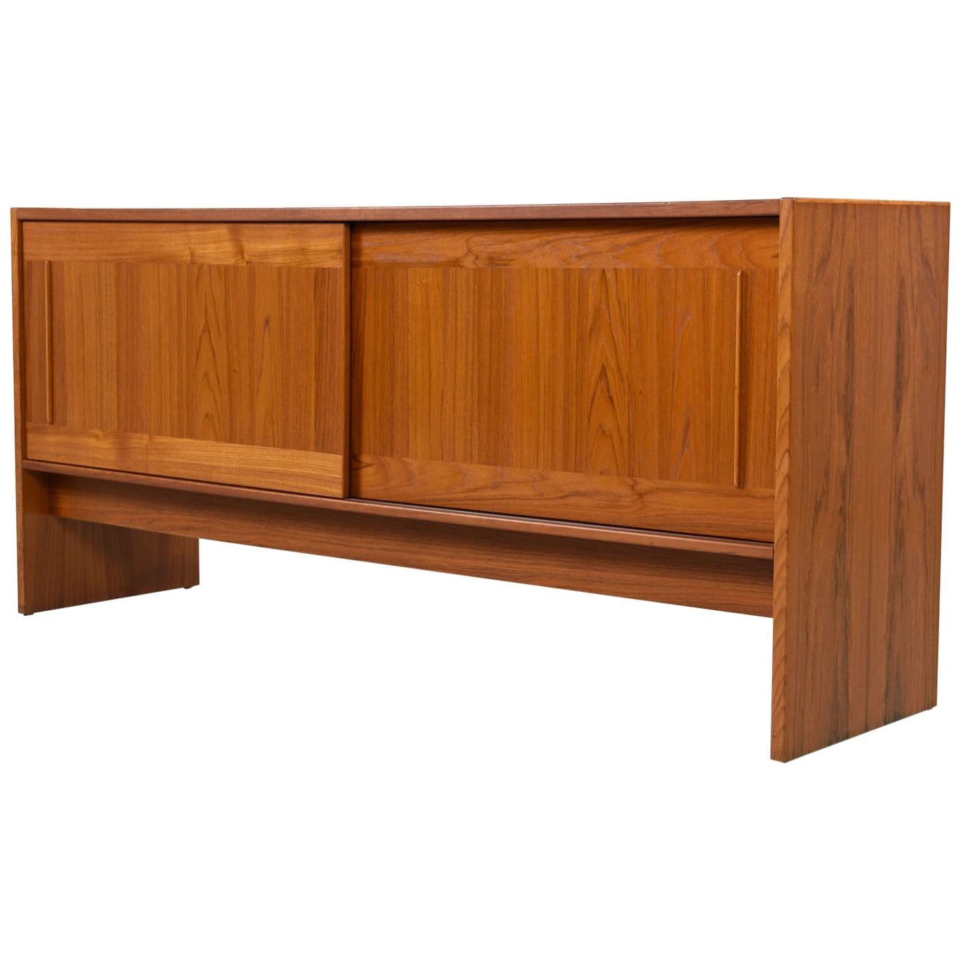 This Danish teak credenza would be perfect in a living room as an entertainment console or in the dining room as a traditional buffet. The unique and distinctive decorative tiles add a fashionable touch to what would otherwise be a familiar,