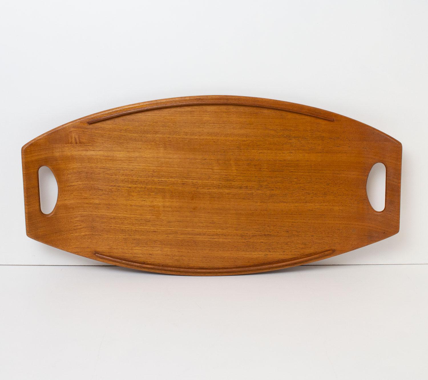 Danish teak tray by Jens Quistgaard, the renowned Danish sculptor and industrial designer who worked prolifically for the American company Dansk Designs in the 1950s and 1960s. His work is in the collections of many museums today including the V&A