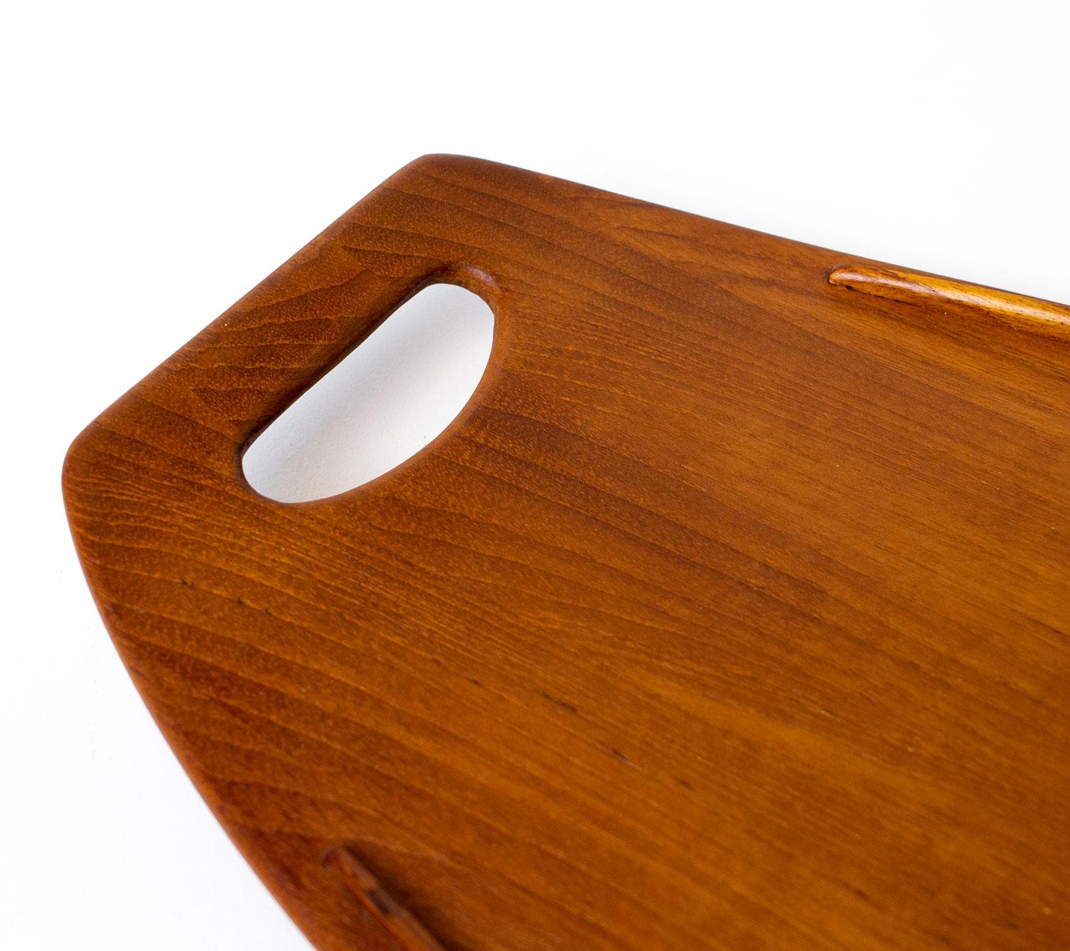 Danish teak tray by Jens Quistgaard, the renowned Danish sculptor and industrial designer who worked prolifically for the American company Dansk Designs in the 1950s and 1960s. His work is in the collections of many museums today including the V&A