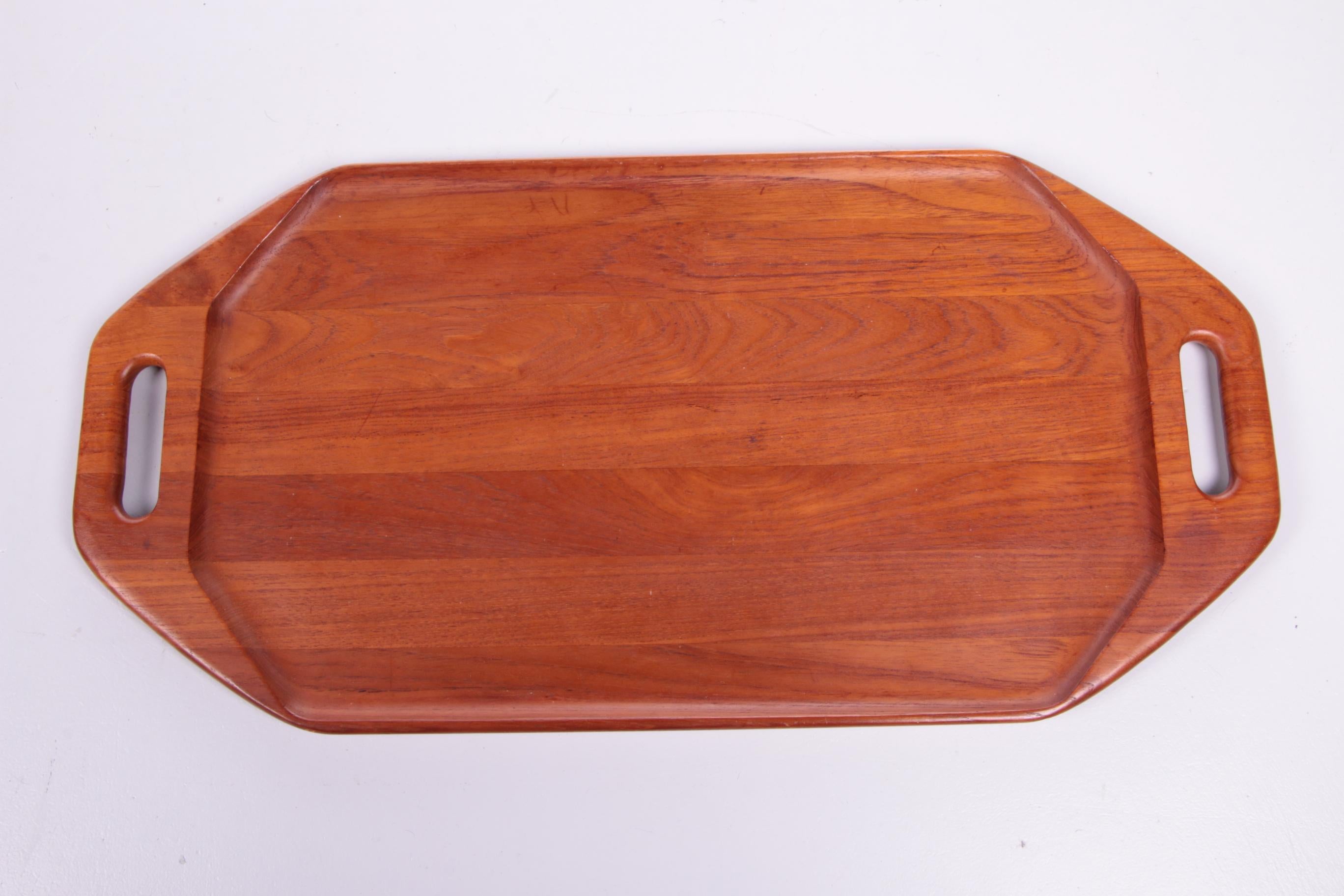 A beautiful teak Digsmed Denmark tray.

This vintage item stands out because of its high-quality and organically finished teak top.

The top feels soft and has a smooth finish, pure Danish craftsmanship.

The colors in the wood are beautiful and