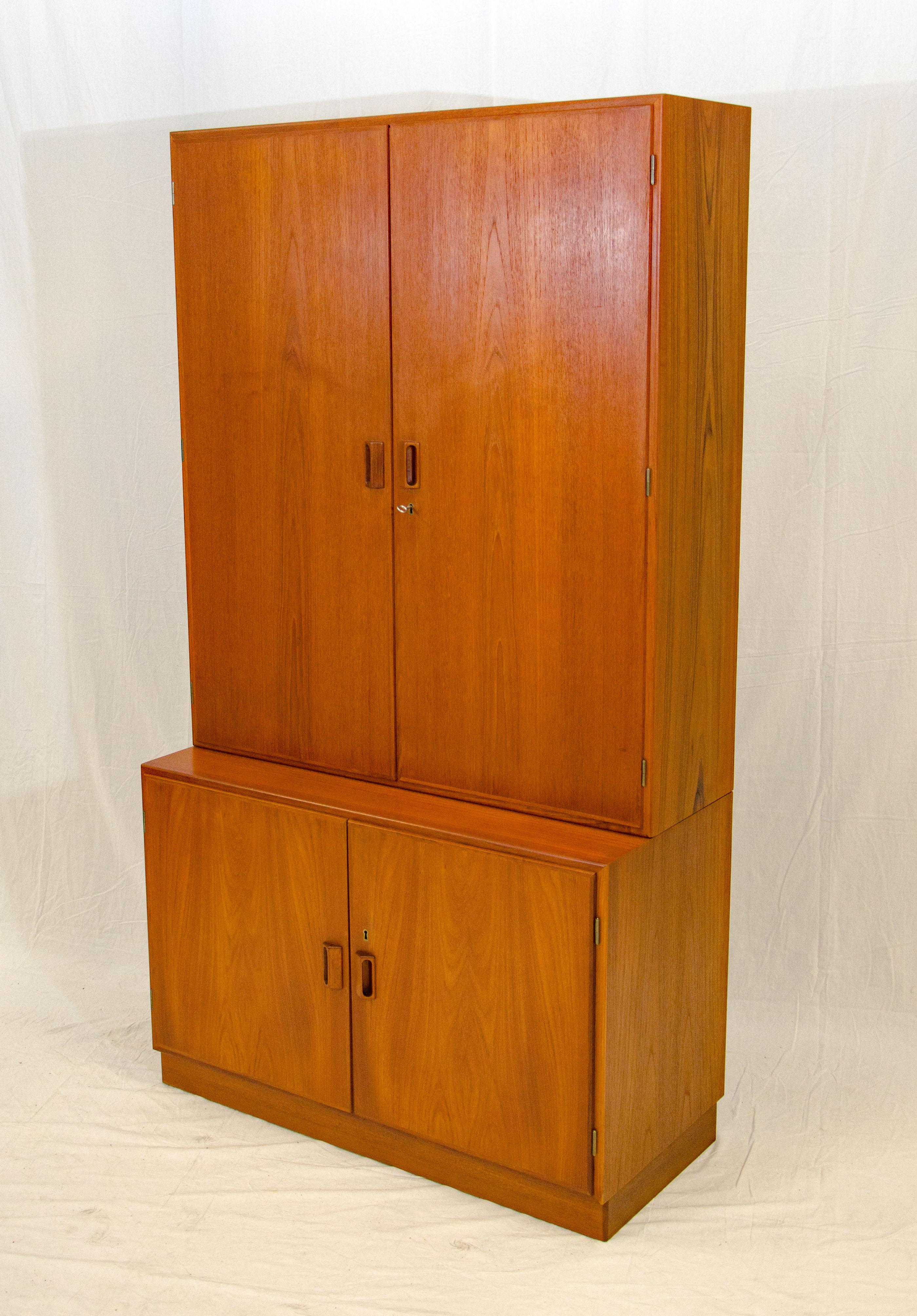 Multi-use Danish teak cabinet with lots of interior shelving, three adjustable shelves are shown but three more shelves are included for possible office, bedroom chifferobe or dresser storage. The shelves have a bevel on the bottom edge for a nice