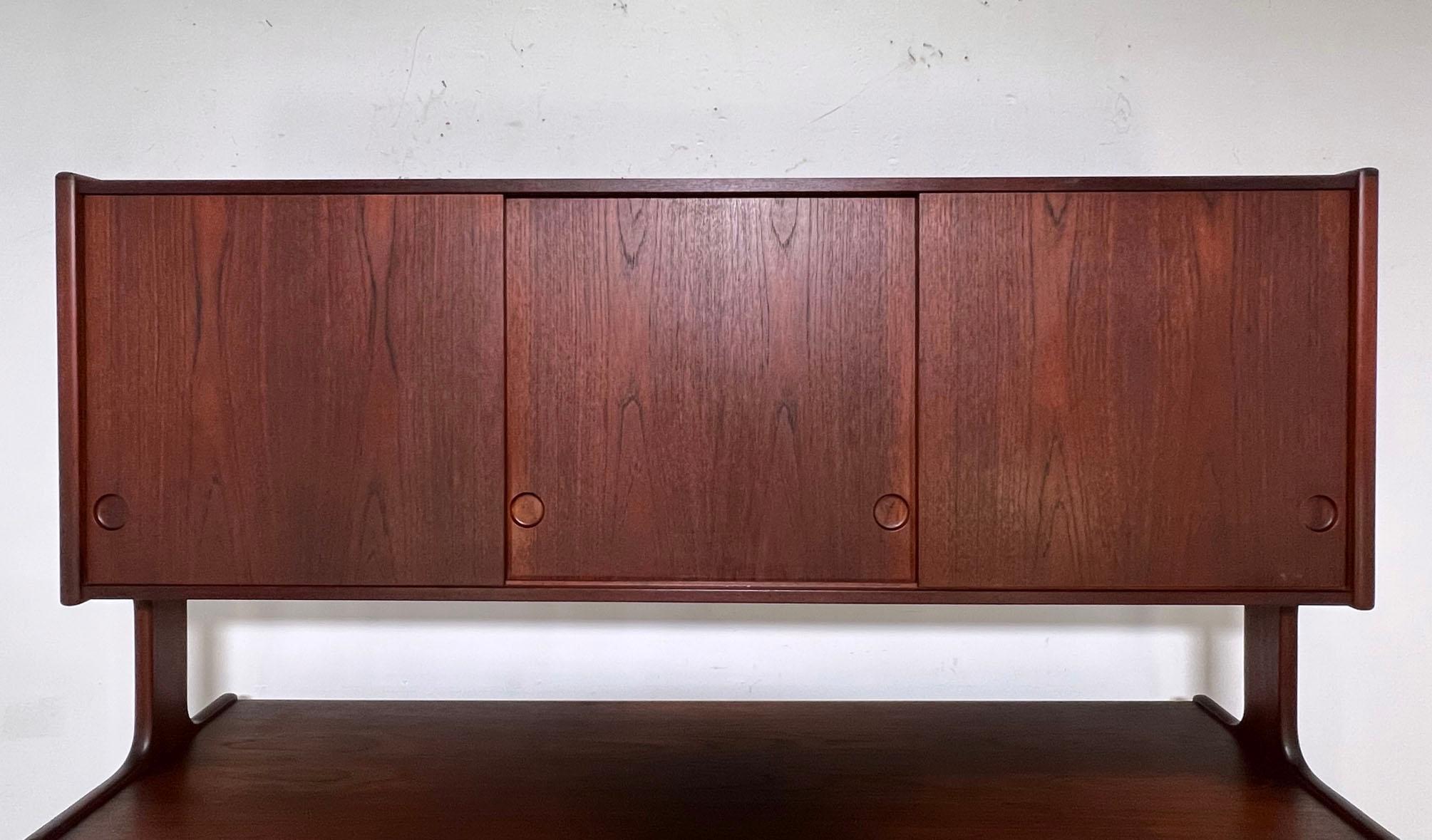 A two-tier Danish teak credenza in the manner of Hans Wegner designs for Ry Mobler.  With its fully finished back, it can also serve as a room divider.