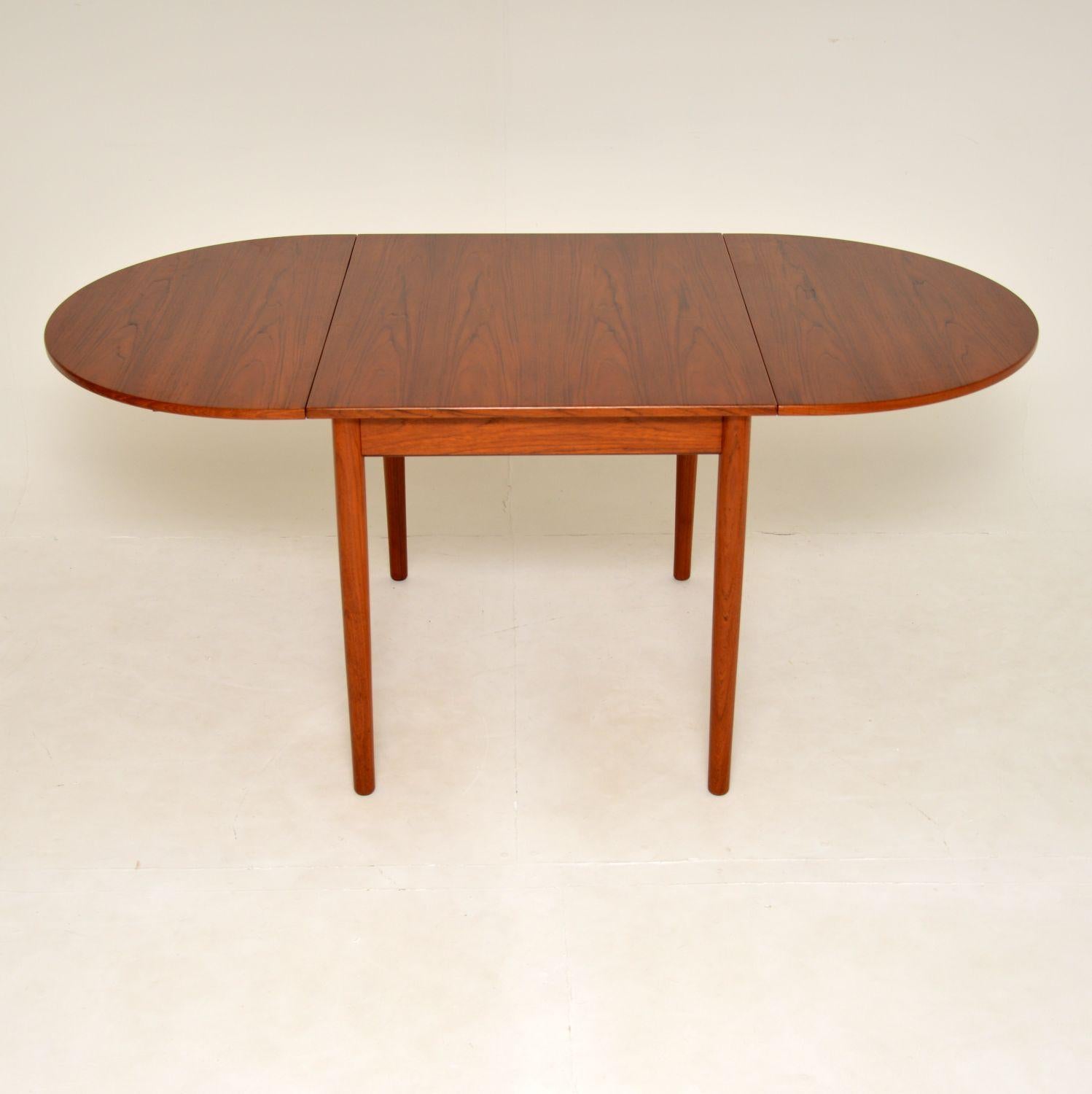 A fantastic and very rare vintage Danish drop leaf dining table in Teak. This was made in Denmark by the high end manufacturer Bernhard Pedersen & Sons, it dates from the 1960’s.

The quality is amazing with superb joinery on display, and this is a