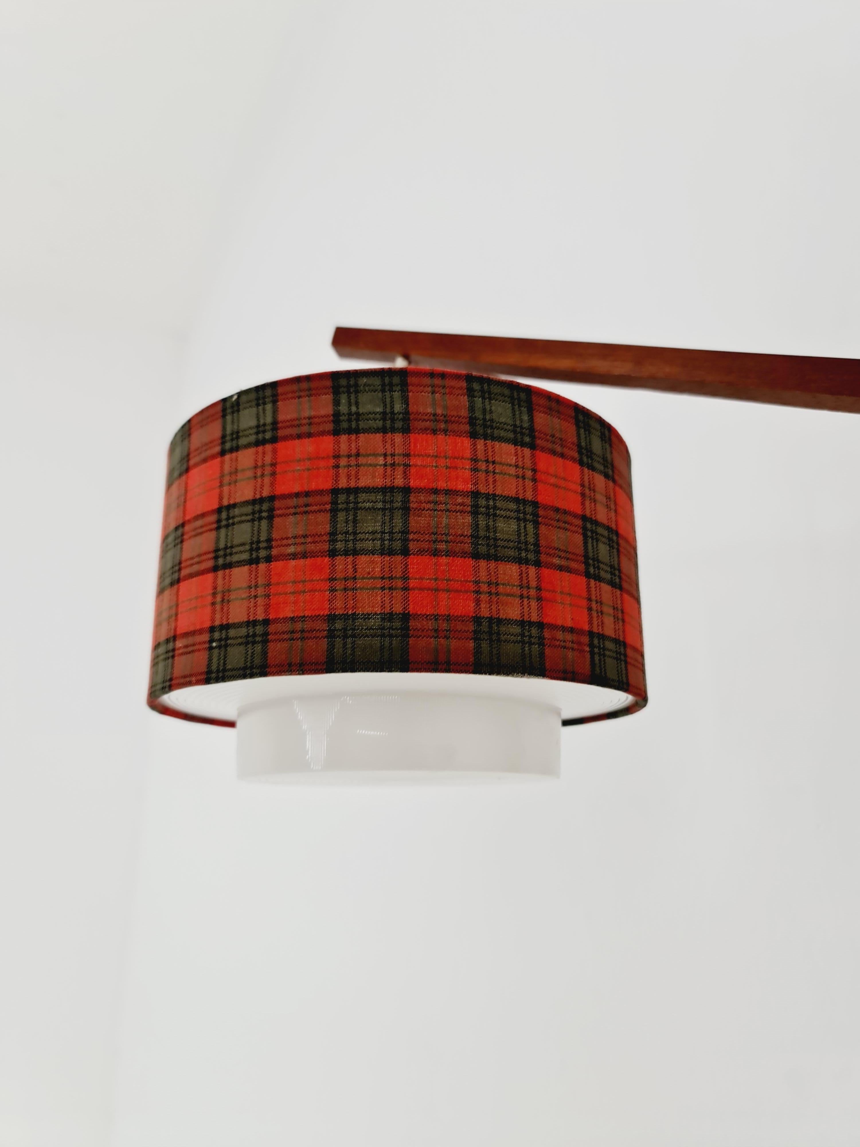 Danish Teak wall Lamp with nice Shade 1960s

Both the shade and the lamp are in amazing condition. 

Measurements:
Height 37   cm
Depth  52 cm
Width :  7 cm