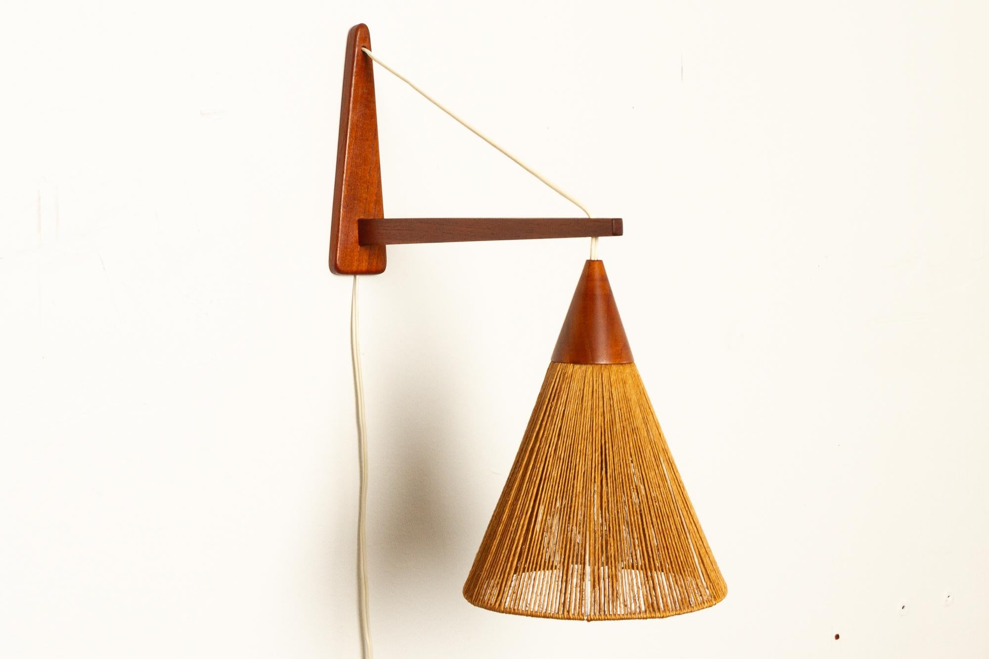 Danish teak wall light by Ib Fabiansen for Fog og Mørup, 1960s.
Danish modern wall lamp in solid teak with shade woven with jute / hemp cords / string. Rarely seen model. Gives off a very cosy and diffused light. Perfect for Danish hygge.
Very