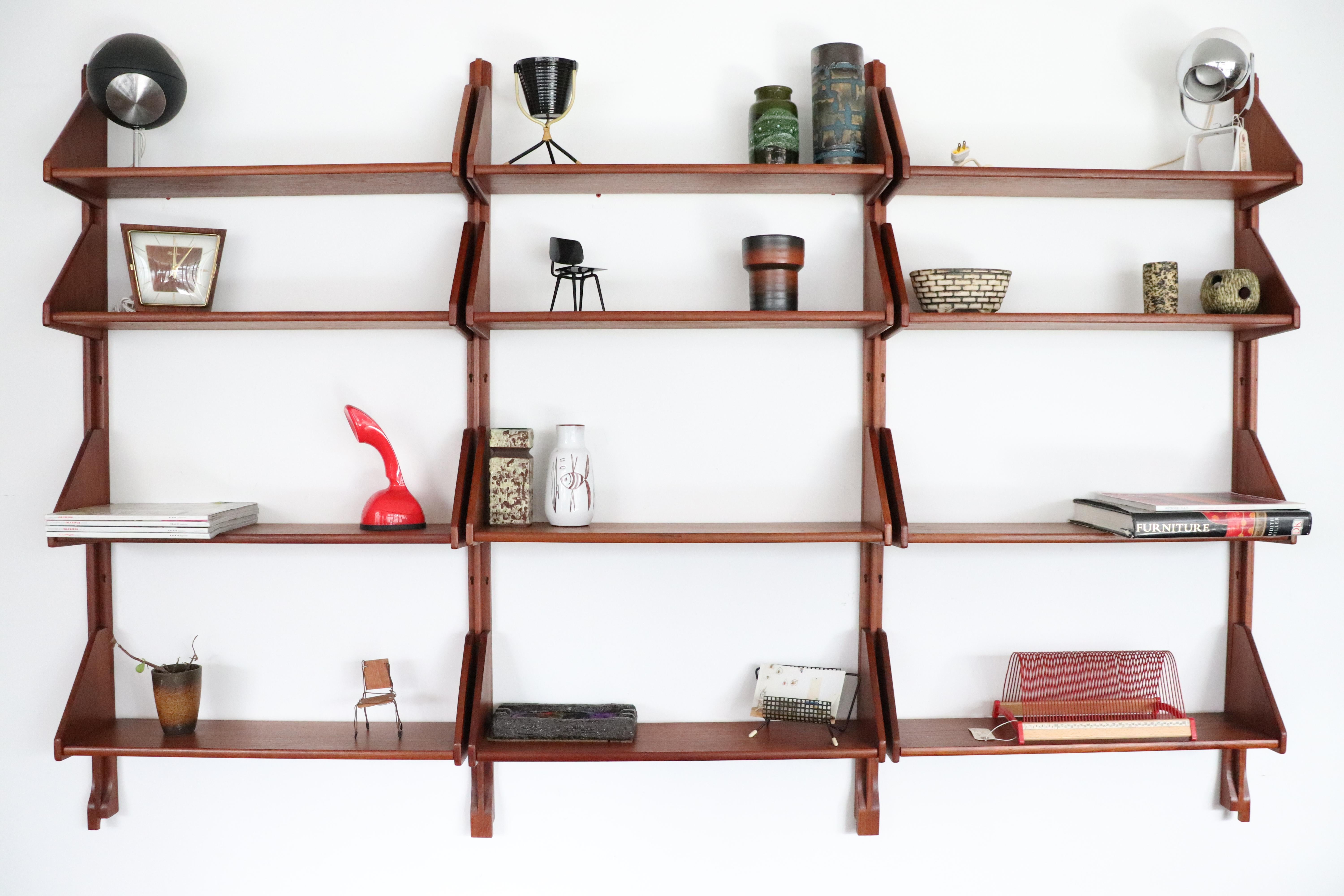 Handsome Danish teak wall mount shelving unit with all wood risers and shelves. Very nice original condition. Accessories, as pictured, not included.