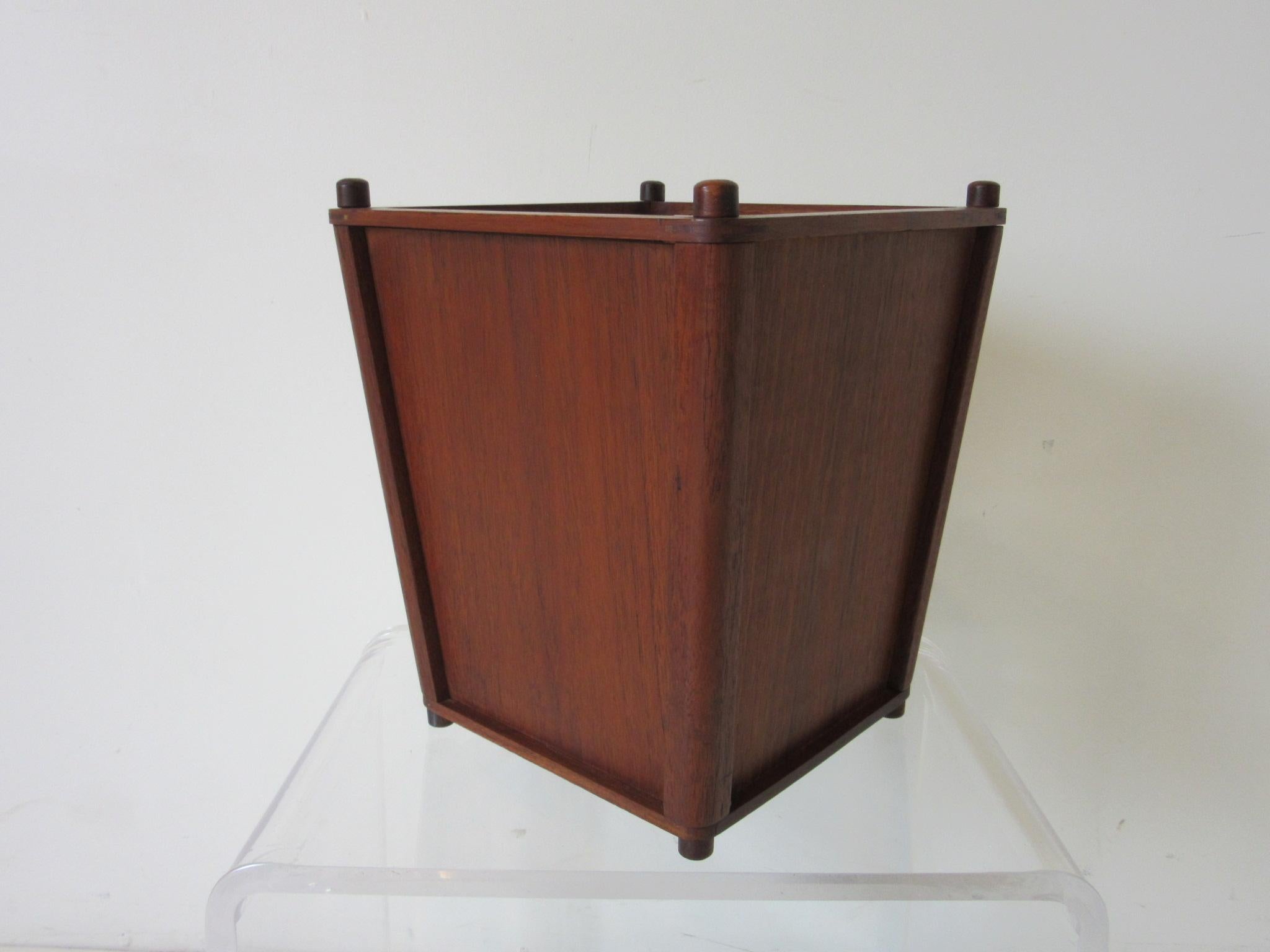 A nice sized and very useful teak wood waste basket with great graining, tapered sides, small feet and detailed pieces to the top. Always the last item which is hard to source to complement that Danish desk and chair to finish off your office design