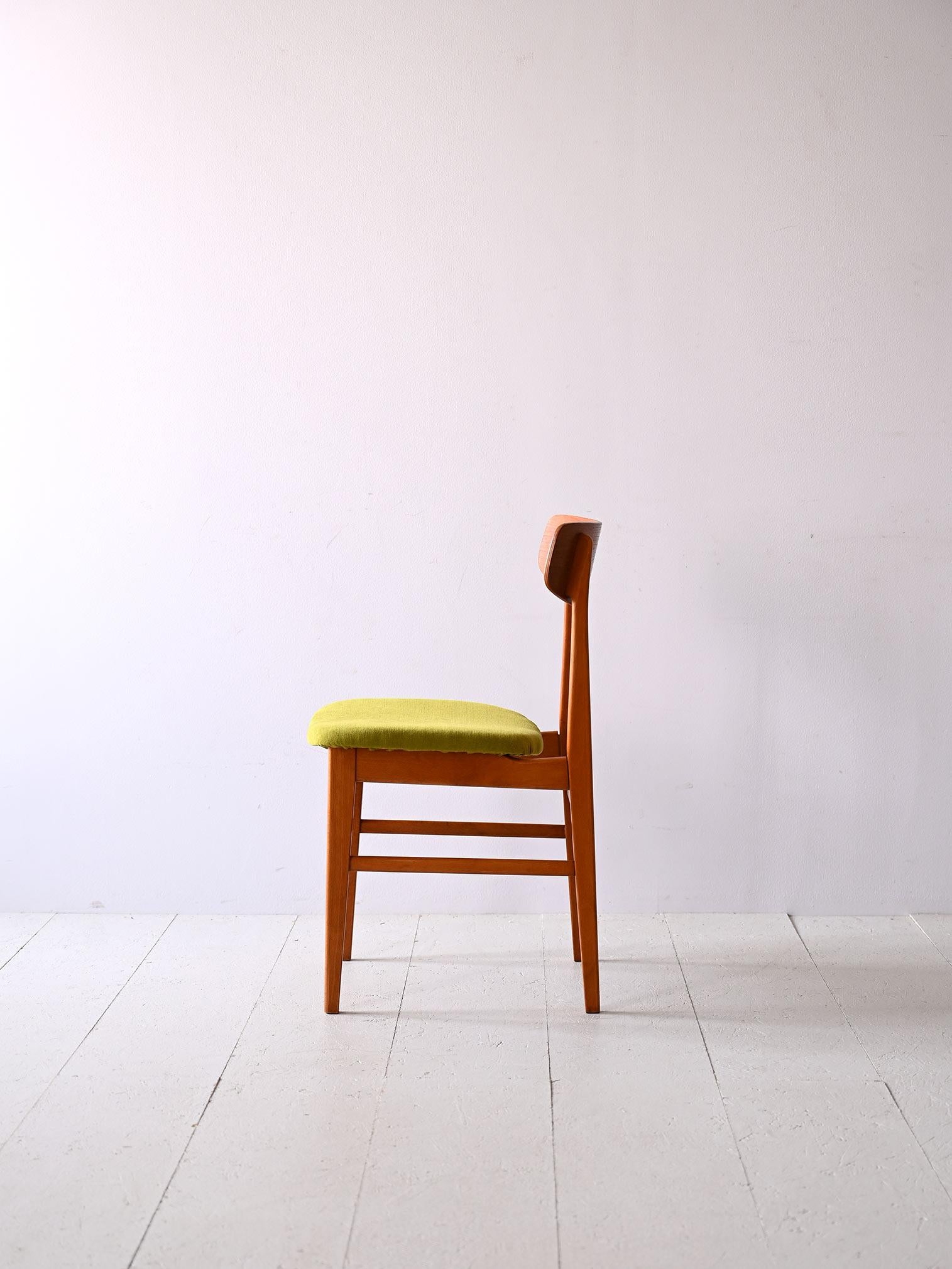 1960s wooden chair.
 
Original Scandinavian chair with simple and elegant lines. Consisting of teak wood frame, it is distinguished by the contoured shape of the backrest. The seat is upholstered and reupholstered with green-colored fabric.
