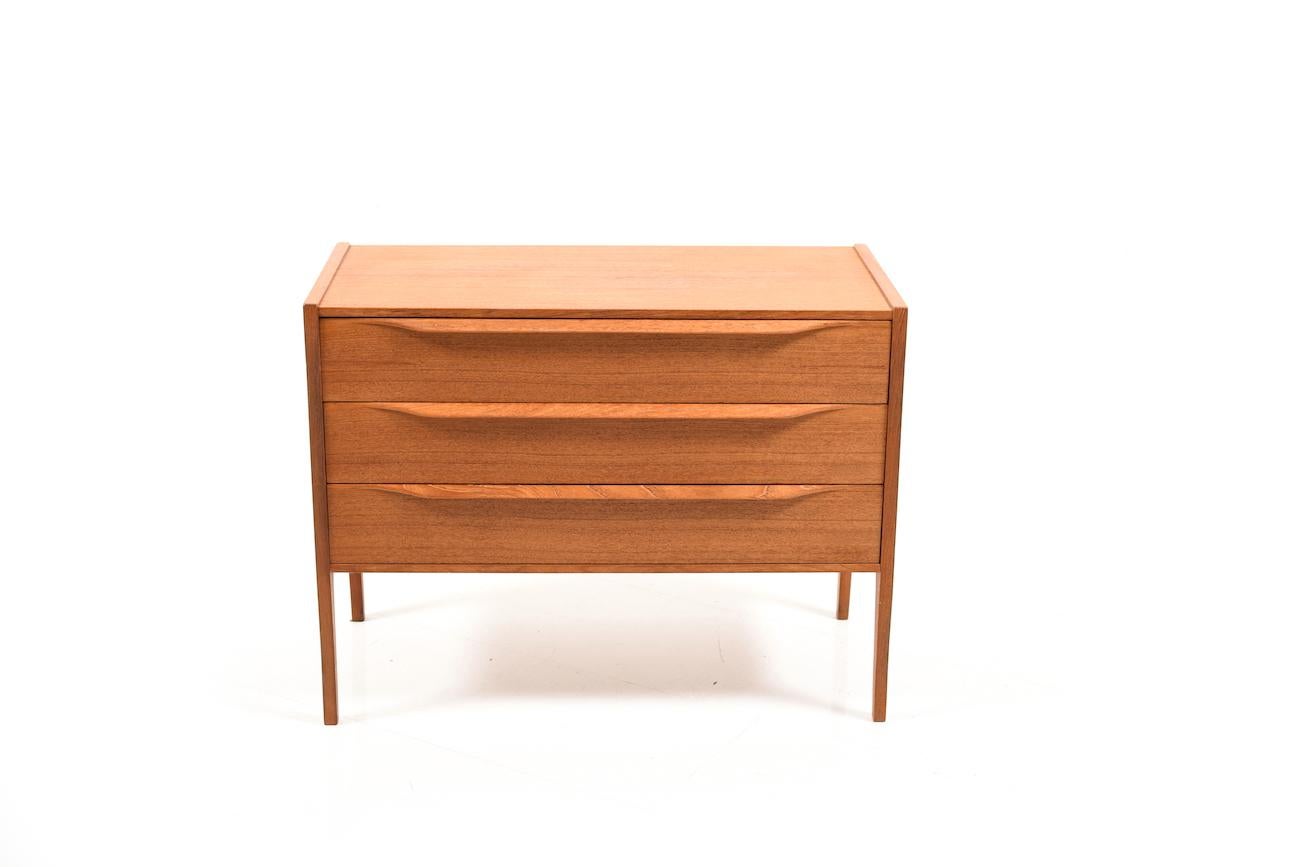 Midcentury Danish teal wooden chest of drawer. Design by Aksel Kjersgaard for Odder Mobelfabrik. Model no.34. In front with three drawers.