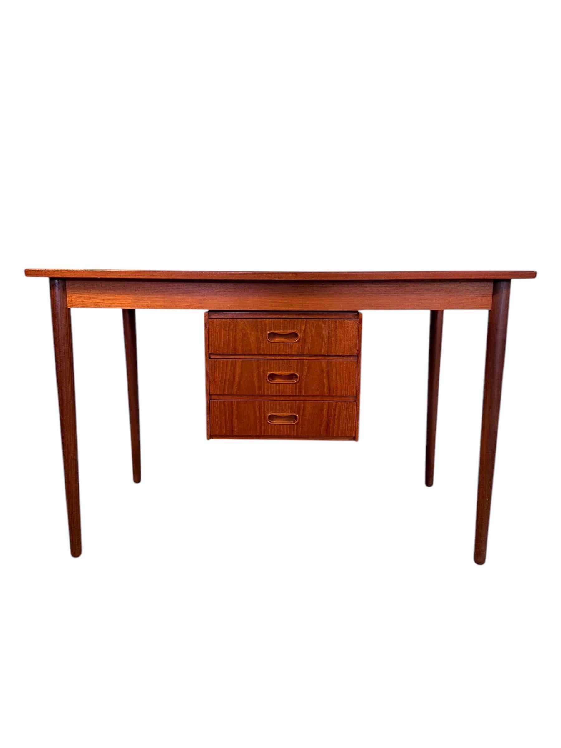Elegant, functional, and full of mid-century charm—this Danish teak writing desk by Arne Vodder is a versatile piece that makes a statement from every angle. Crafted in the 1960s, it features a clean-lined silhouette with beautifully tapered legs