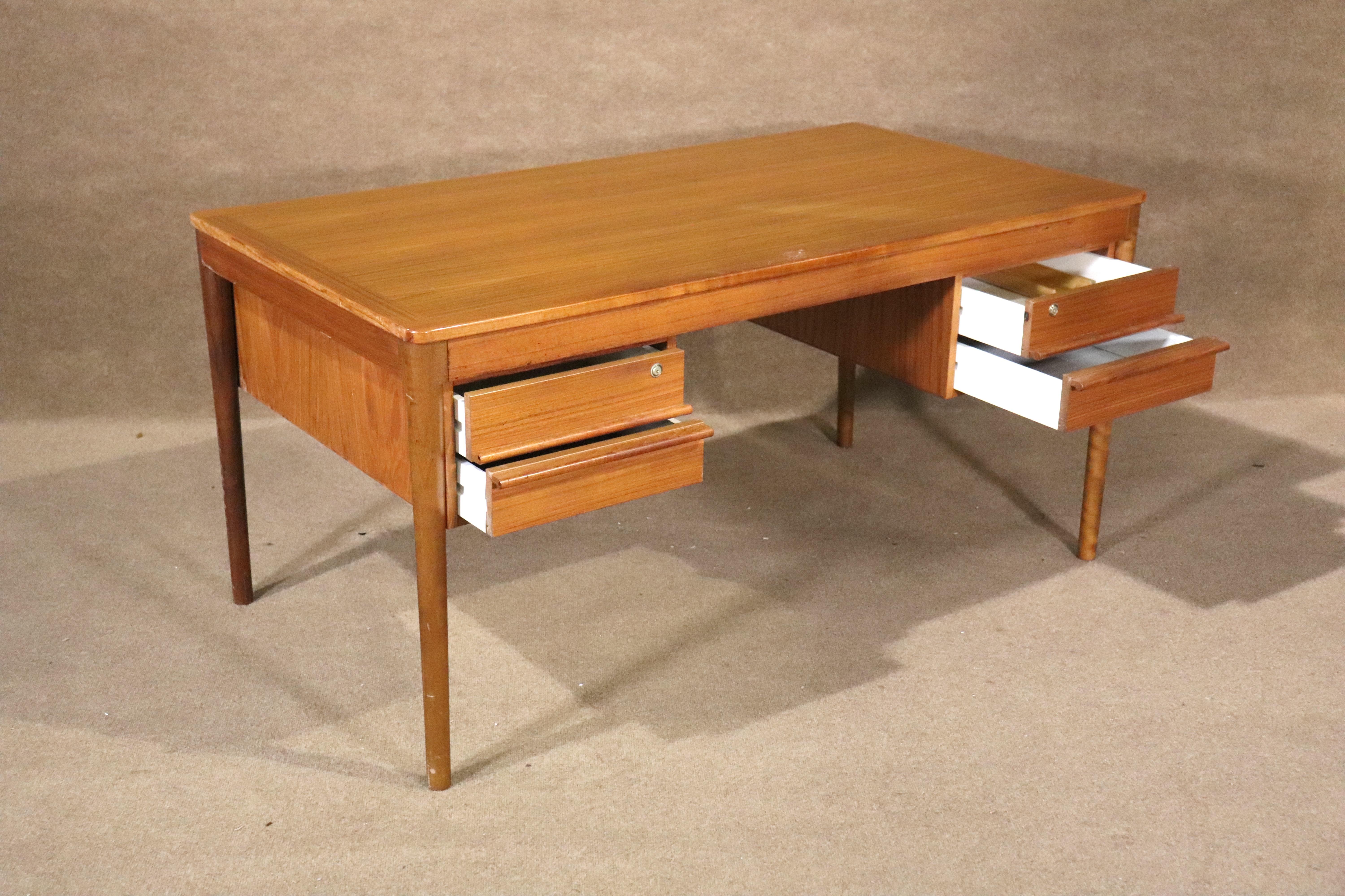 Danish made mid-century modern desk in teak wood grain. Four drawers and finished back.
Please confirm location NY or NJ