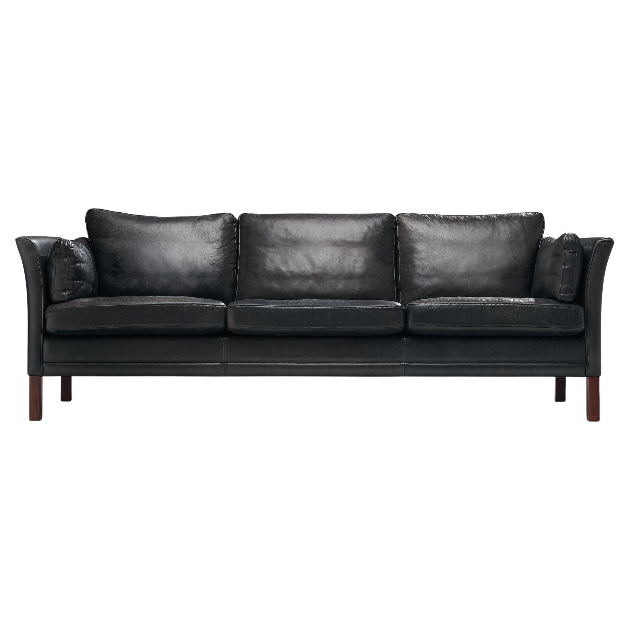 Sofa, leather, wood, Denmark, 1960s

A beautiful three seat sofa made in Denmark in the 1960s. This model reminds of Borge Mogensen's designs. The black leather shows a light patina and is in great condition. The dawn-filled cushions create a
