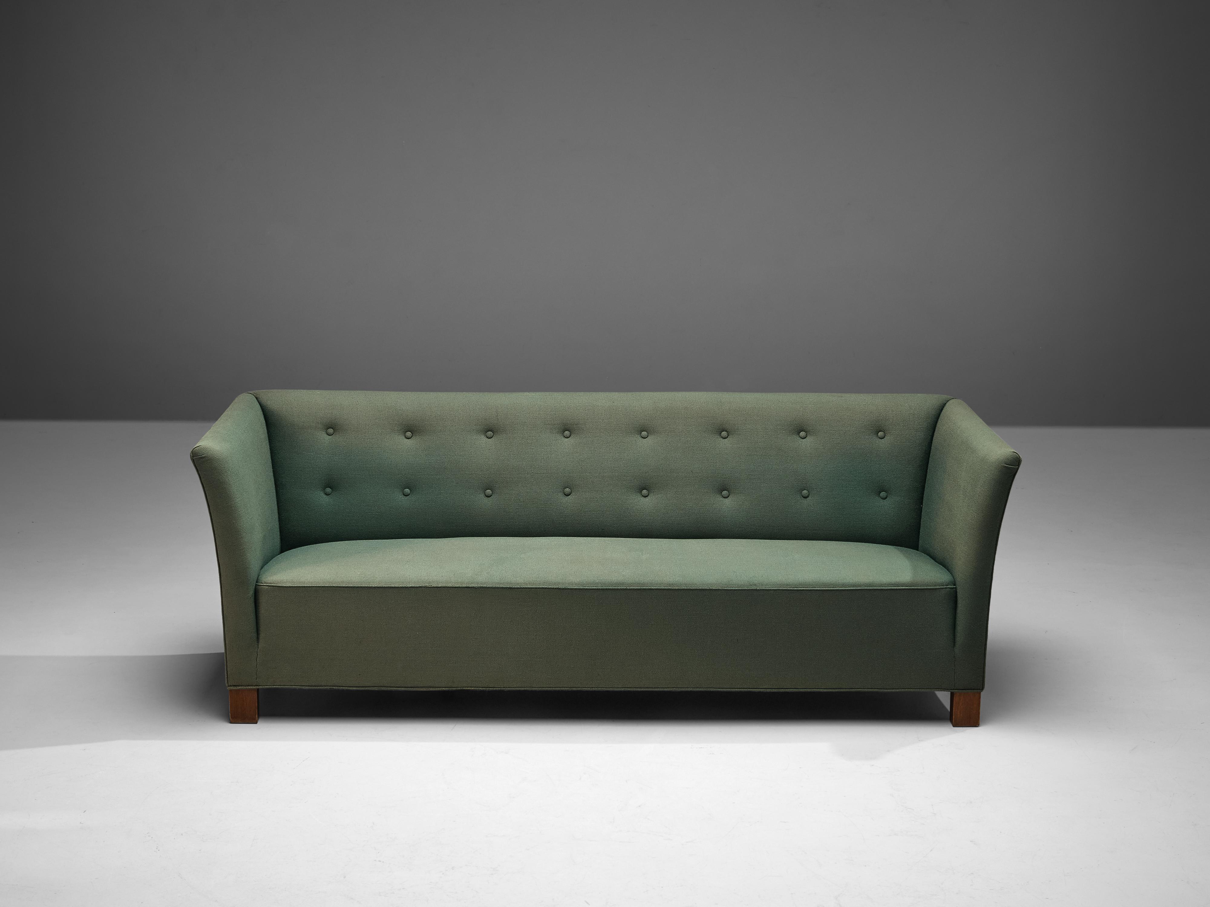 Three-seat sofa, velvet and wood, Denmark, 1940s

This comfortable sofa has a sturdy appearance, with elegant armrests that are slightly curved. This graceful look is emphasized by the decorative cushions and the sleek overall look. The sofa is