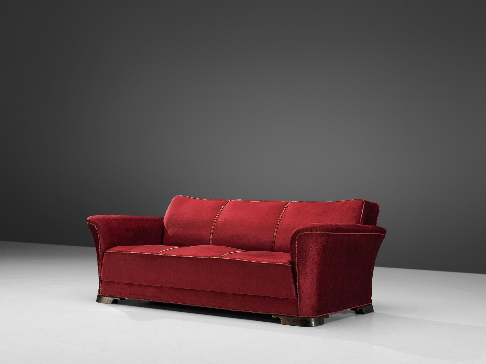 Three-seat sofa, velours and mahogany, Denmark, 1940s

A grand and comfortable three-seat sofa in red velours upholstery. The sofa features a thick seat, which is characteristic for the Art Deco movement. Large upsweeping armrests curve slightly