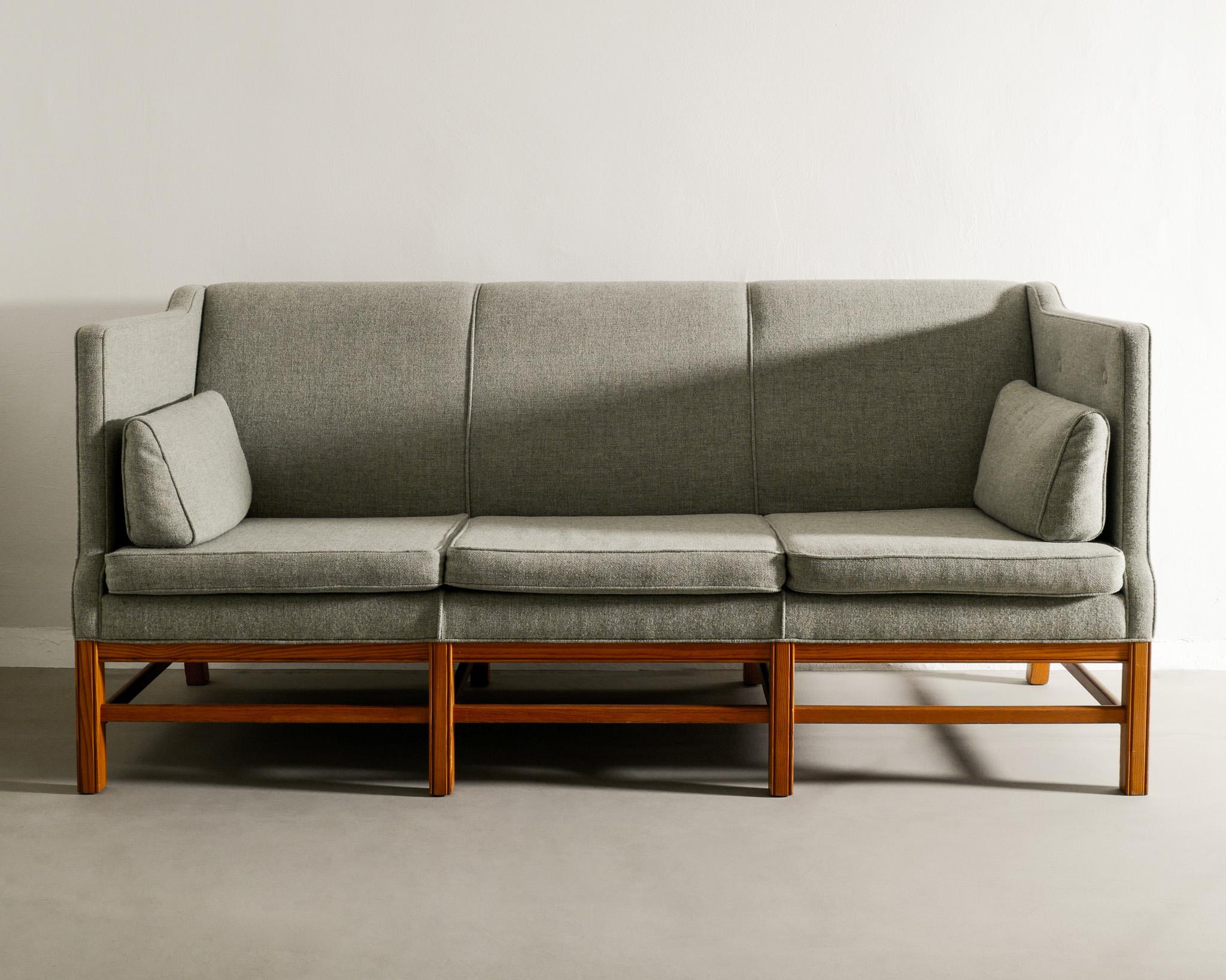 Rare mid century three seater pine sofa in style of Kaare Klint produced in Denmark, 1960s. In great condition newly upholstered in light green wool fabric. 

Dimensions: H: 89 cm / 35