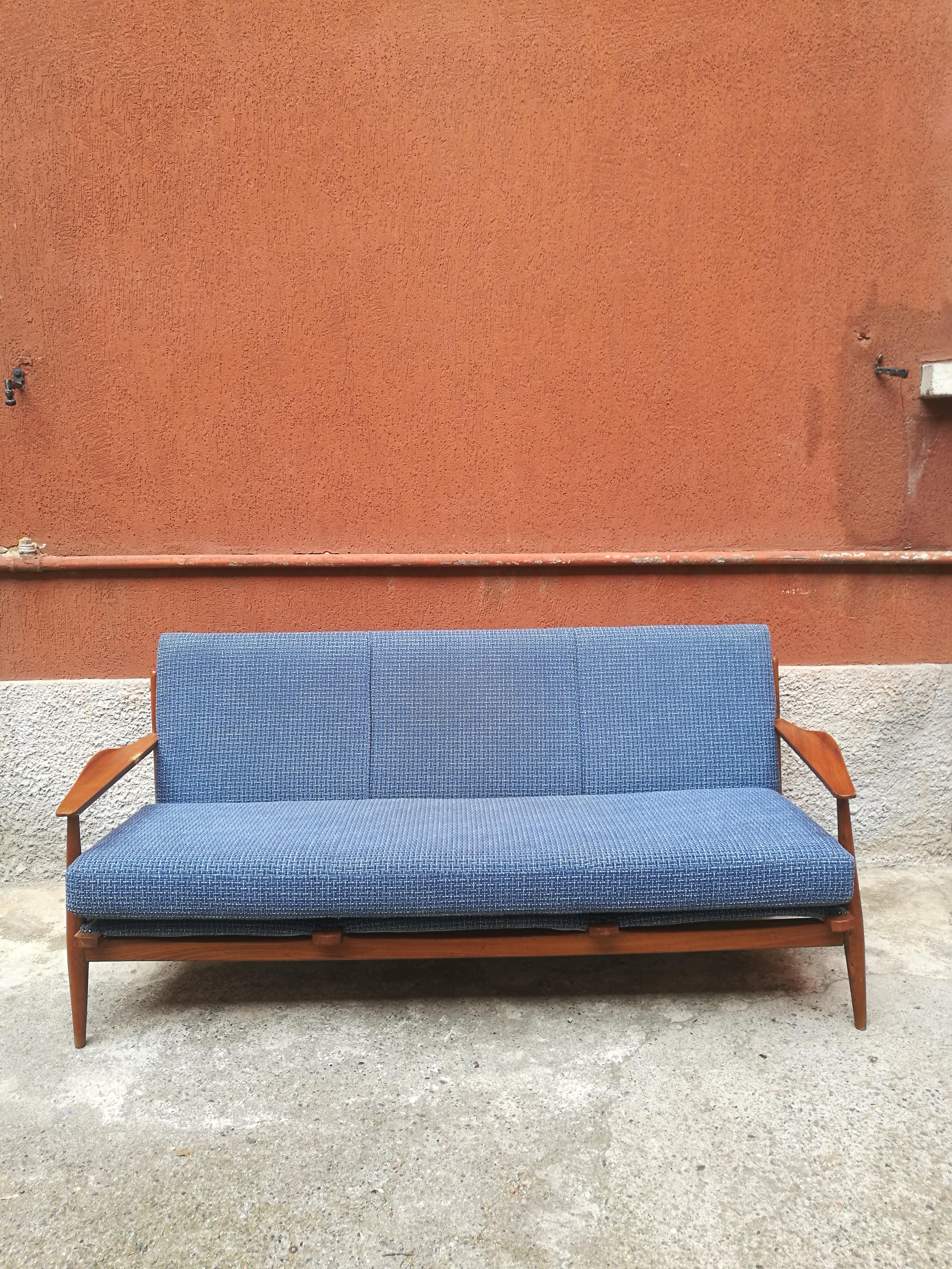 Danish three-seat sofa with armrests, 1960s
Danish light blue sofa from 1960s. Its a three-seat sofa with a cotton fabric, while all the structure is teak made. The fabric has a really unusual texture, present in the backside of the sofa, that can