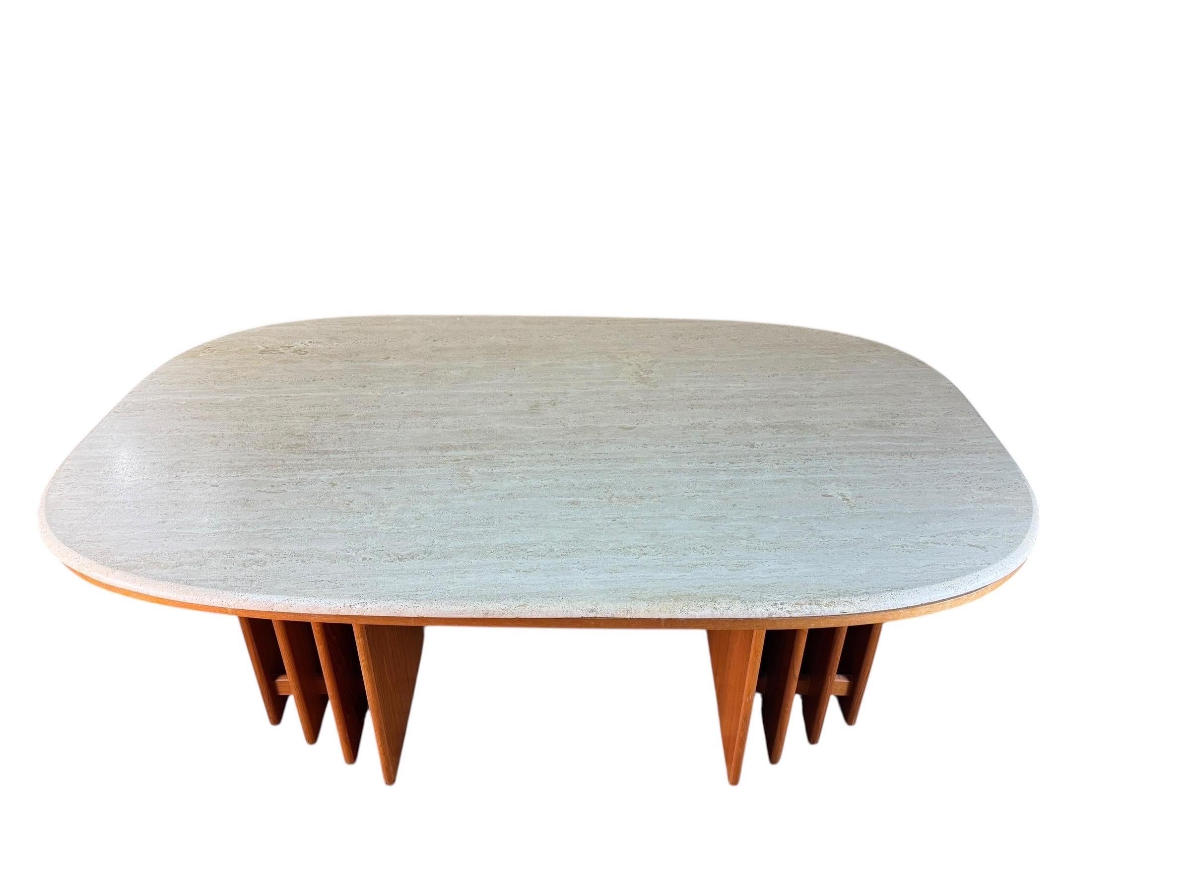 For sale is this very unique and hard to find danish dining table made by Marmorhuset. The table is constructed of two teak bases with a travertine top.