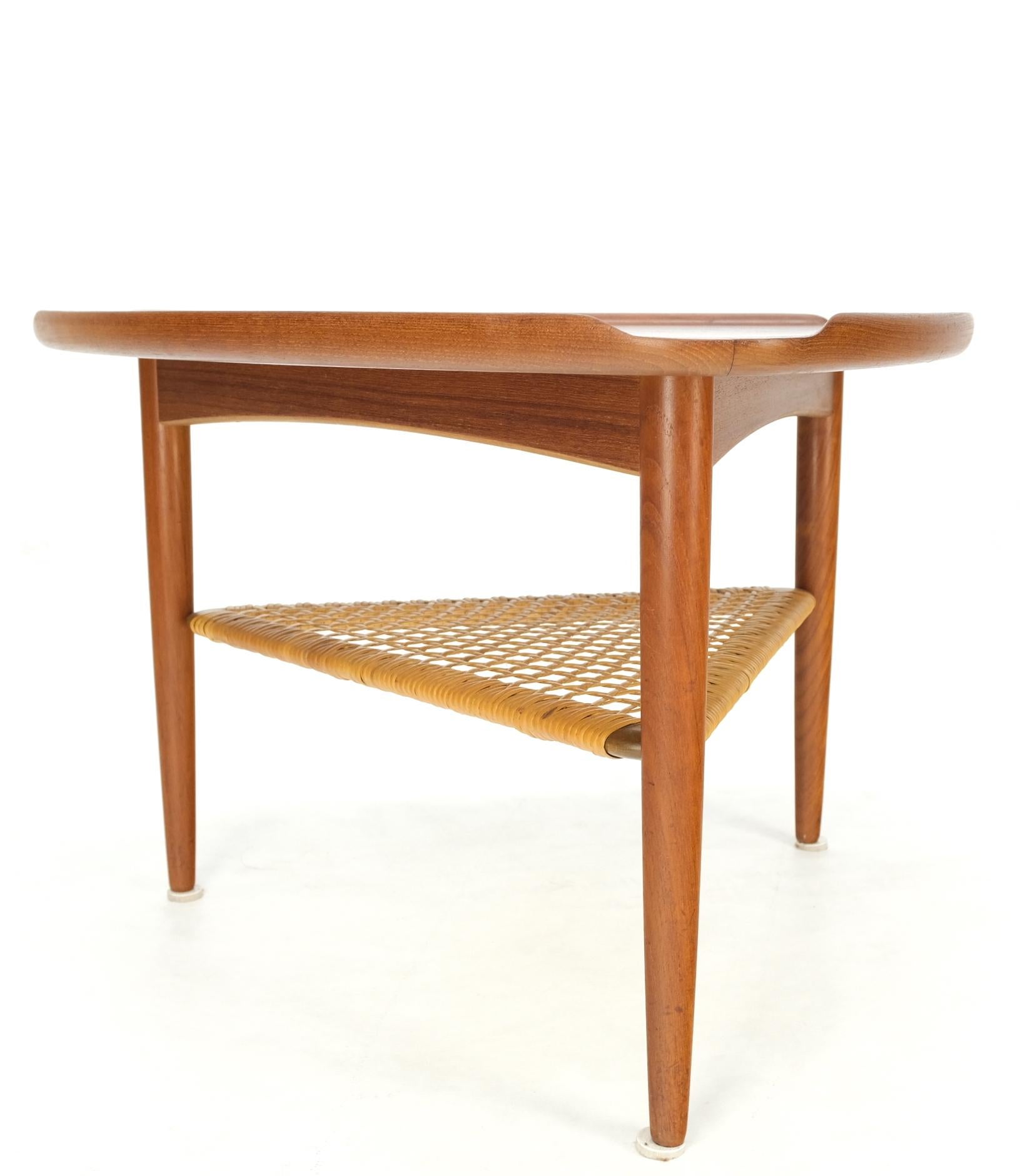 Danish Triangular teak rolled edge caned shelf end side occasional table stand.