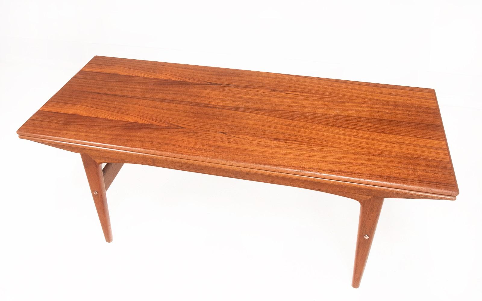 Metamorphic dining table 

A 1960s teak metamorphic dining table by Trioh. Know as the elevator table, and the innovative design sees the coffee table transform into a dining table capable of seating six people. 

Extra leaves are concealed