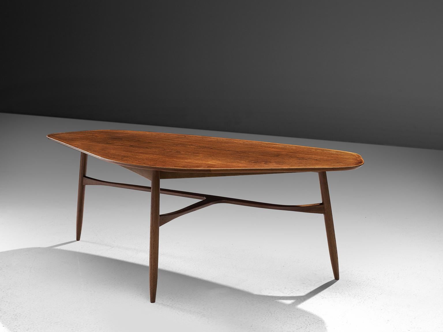 Coffee table, teak, Denmark, 1950s. 

This freely shaped coffee table with three thin tapered legs is part of our Scandinavian midcentury design collection. The legs of the table are beautifully shaped and show high attention to detail, especially