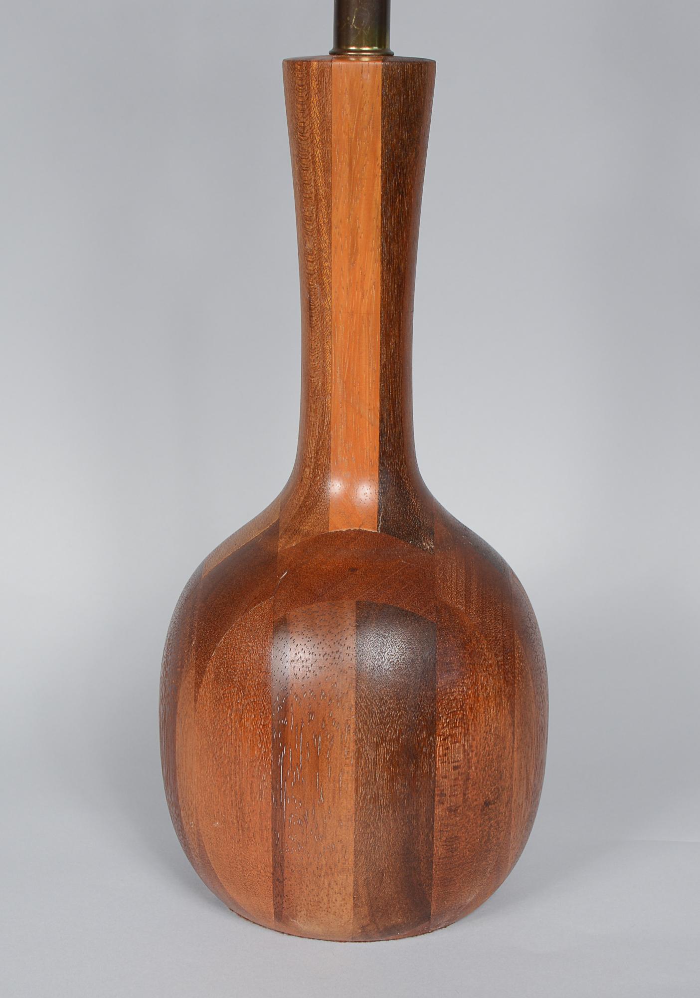 Turned solid teak table lamp in a bottle form. This lamp has a rich beautiful grain. Height to the bottom of the socket is 16 inches.