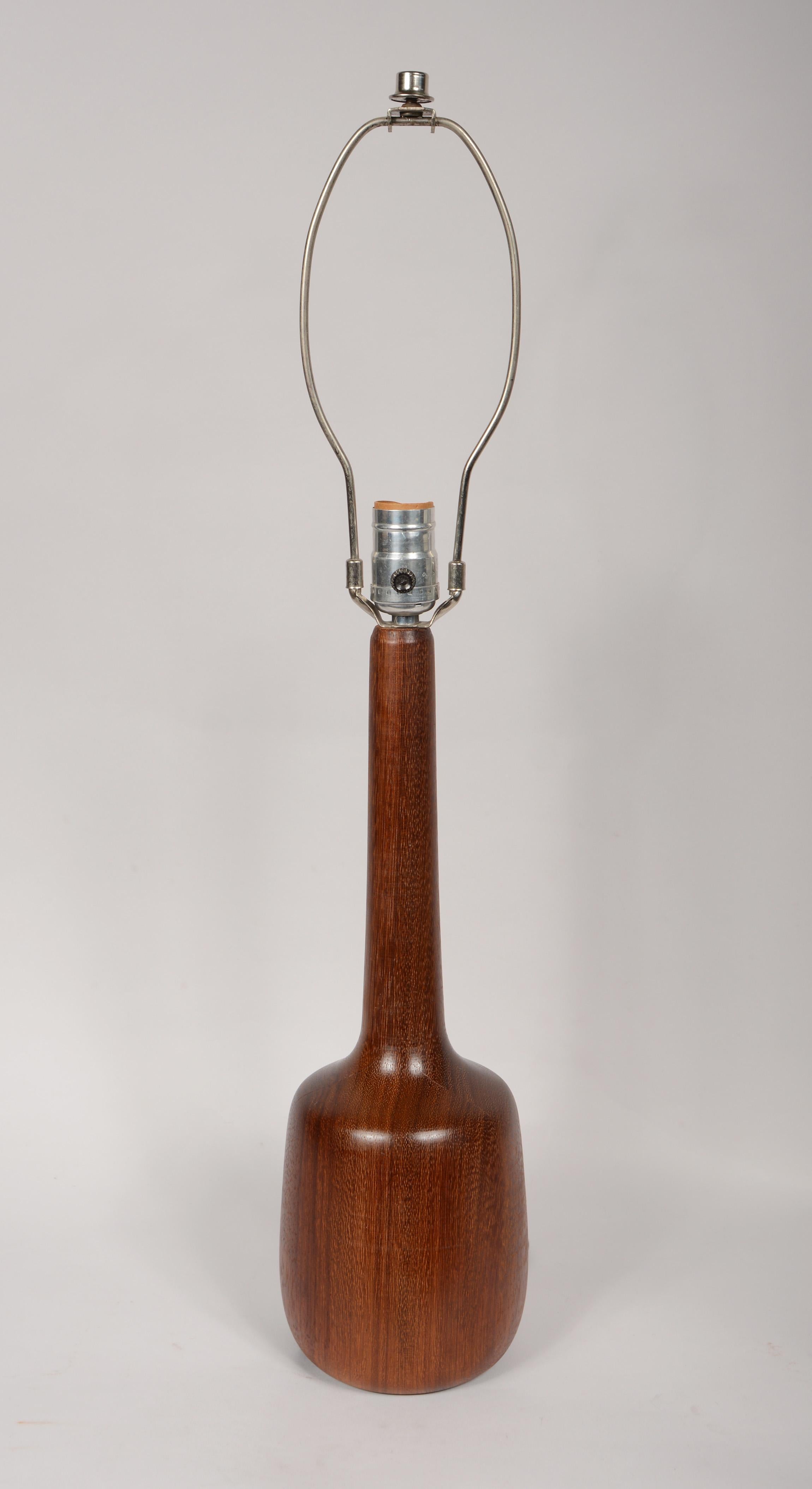 Turned solid teak table lamp. This lamp has a rich beautiful grain. Height to the bottom of the socket is 16 inches.